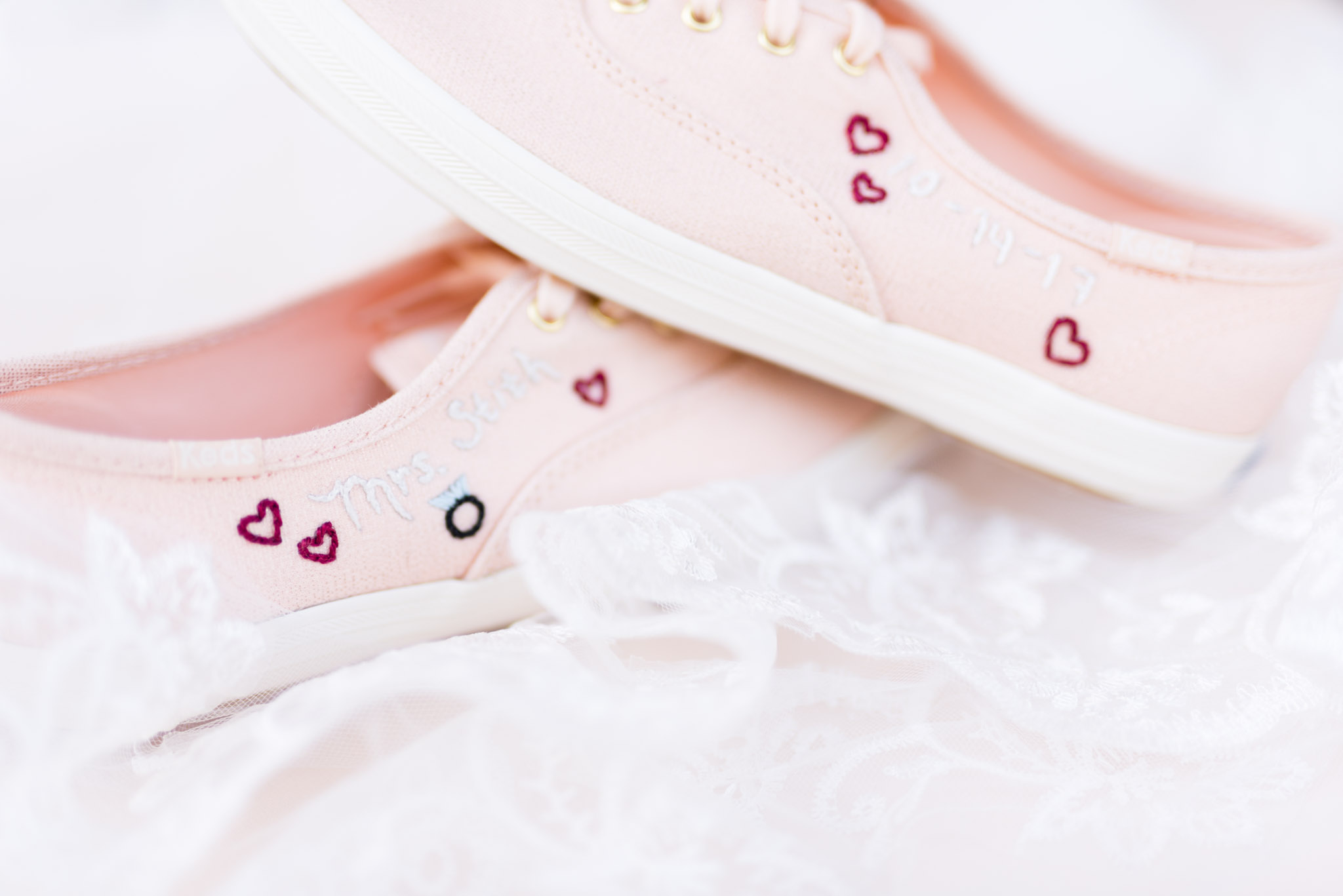 Bride's Embroidered Pink Keds on top of veil.