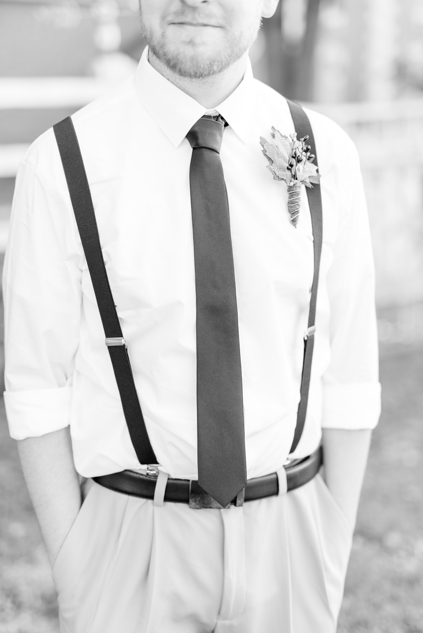 Closeup of Groom's shirt, tie, and suspenders.