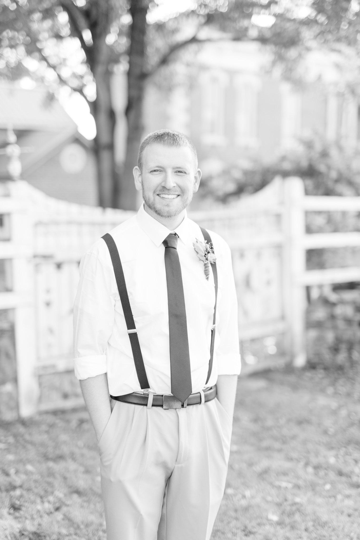 Groom smiles at camera on wedding day.