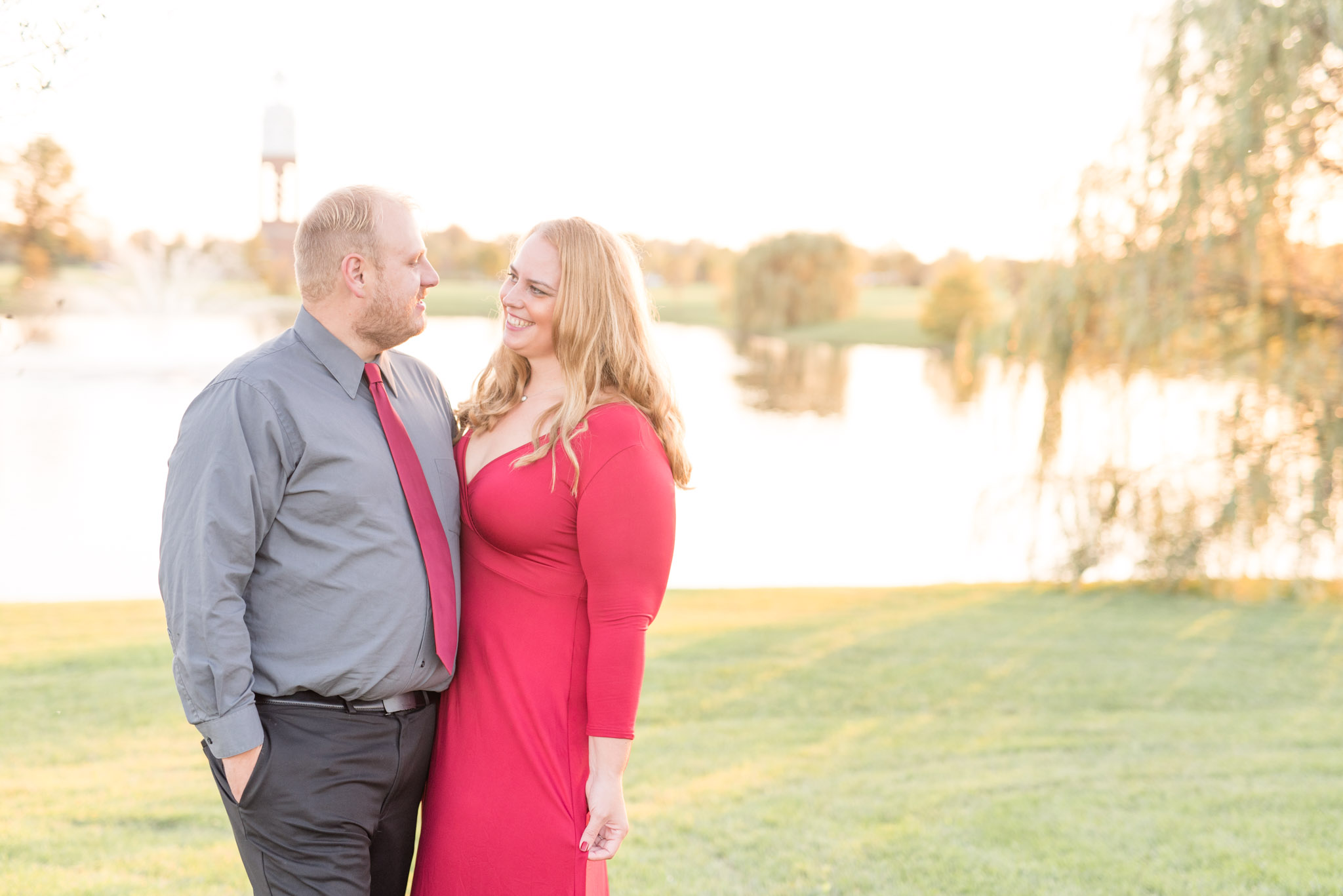 Man and woman smile at each other at sunset.