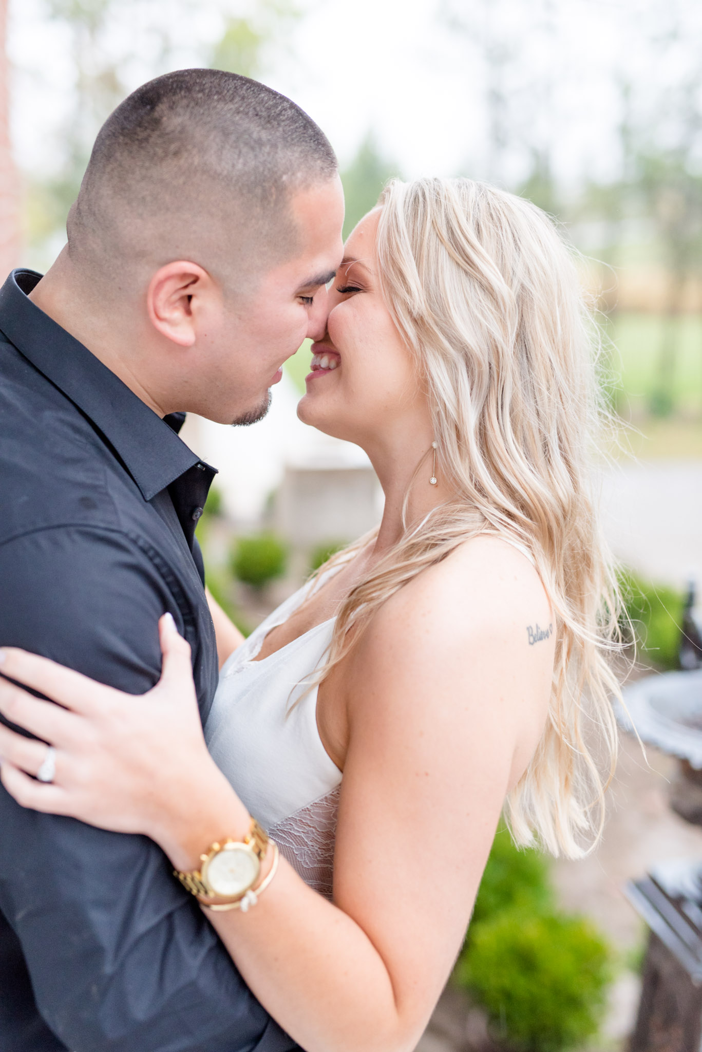 Groom leans bride back during engagement pictures.