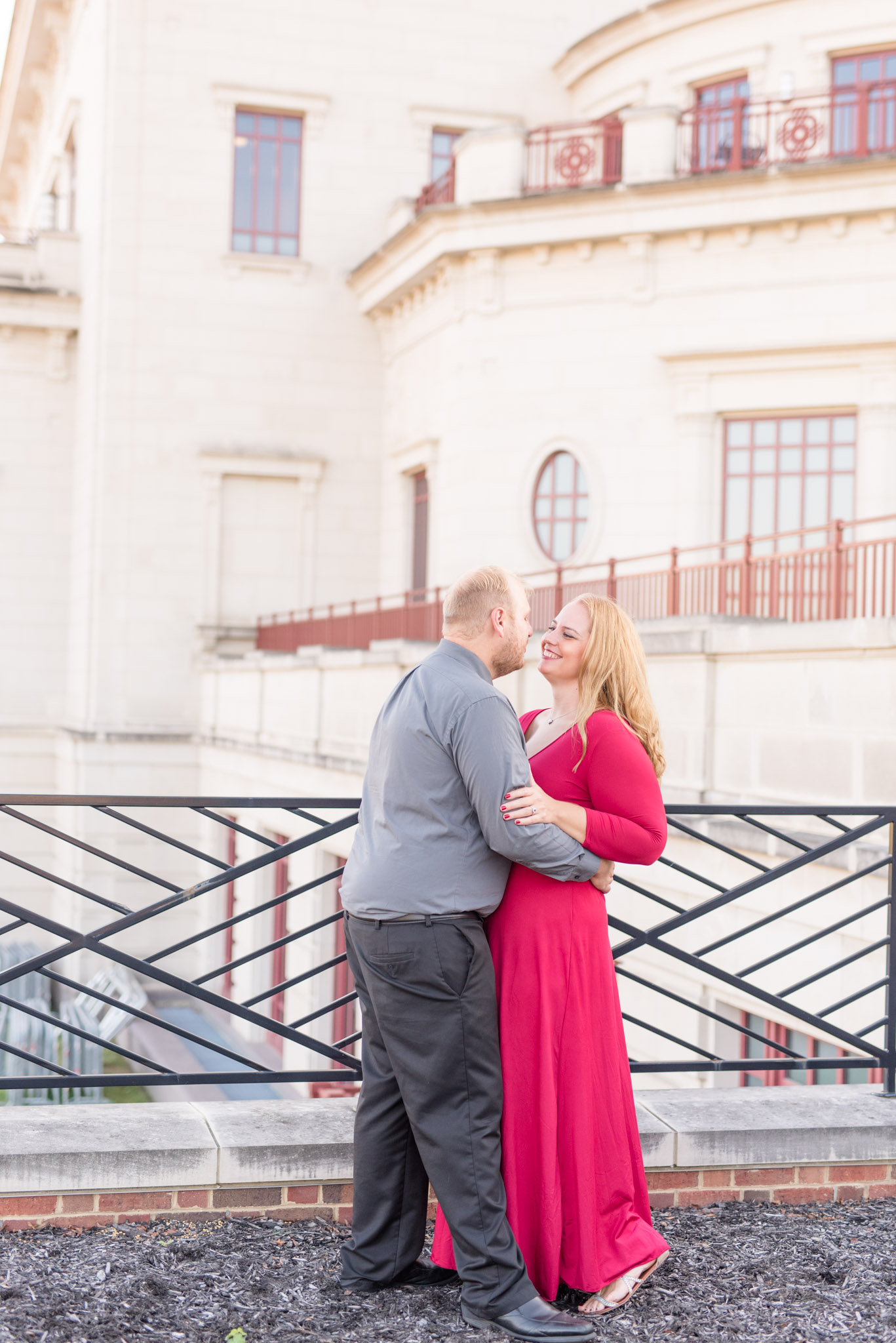 Engaged man and woman hold eachother in urban setting.