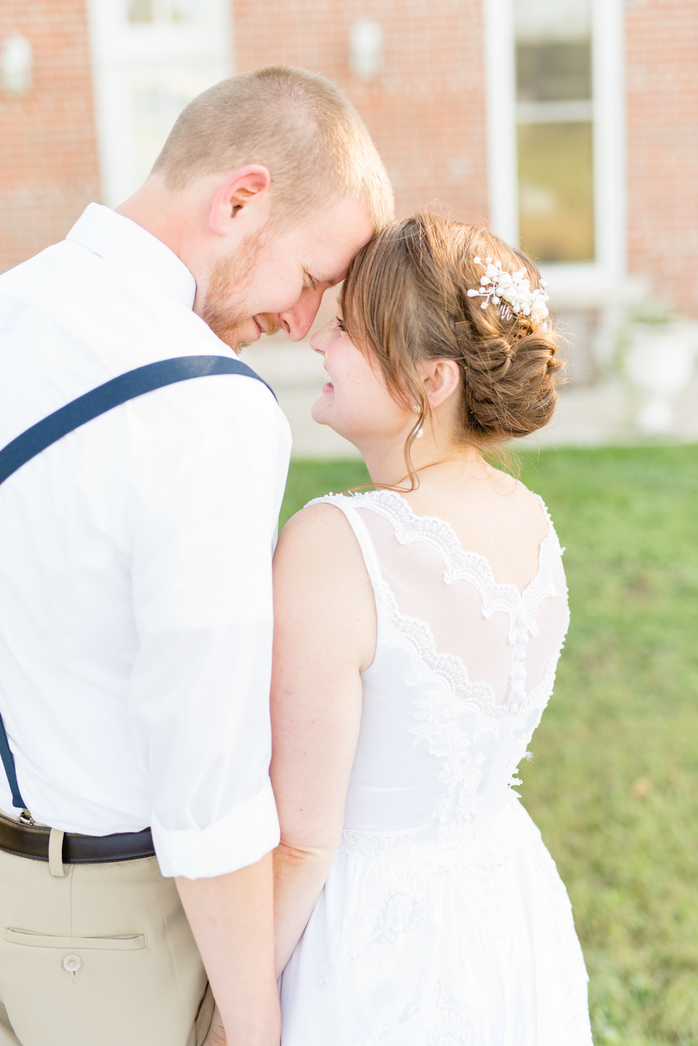 Bride and groom touch foreheads.