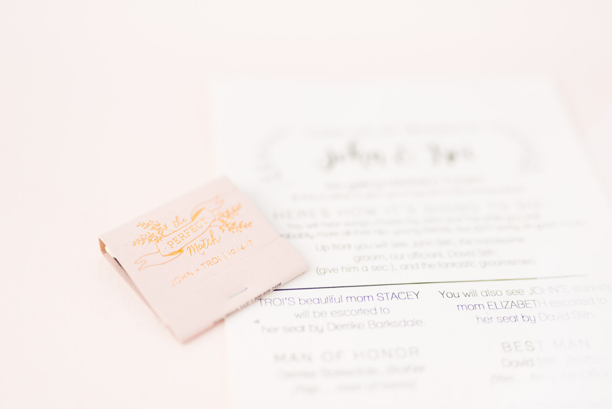 Wedding Matchbook favor sits on wedding program.