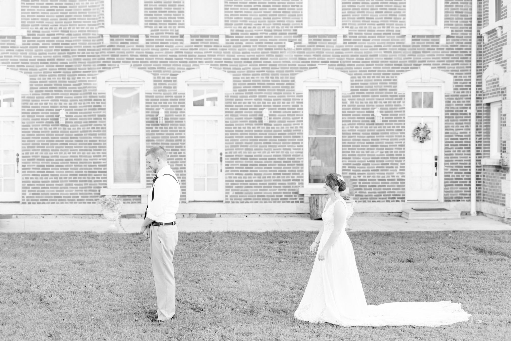 Bride walks towards groom during first look.