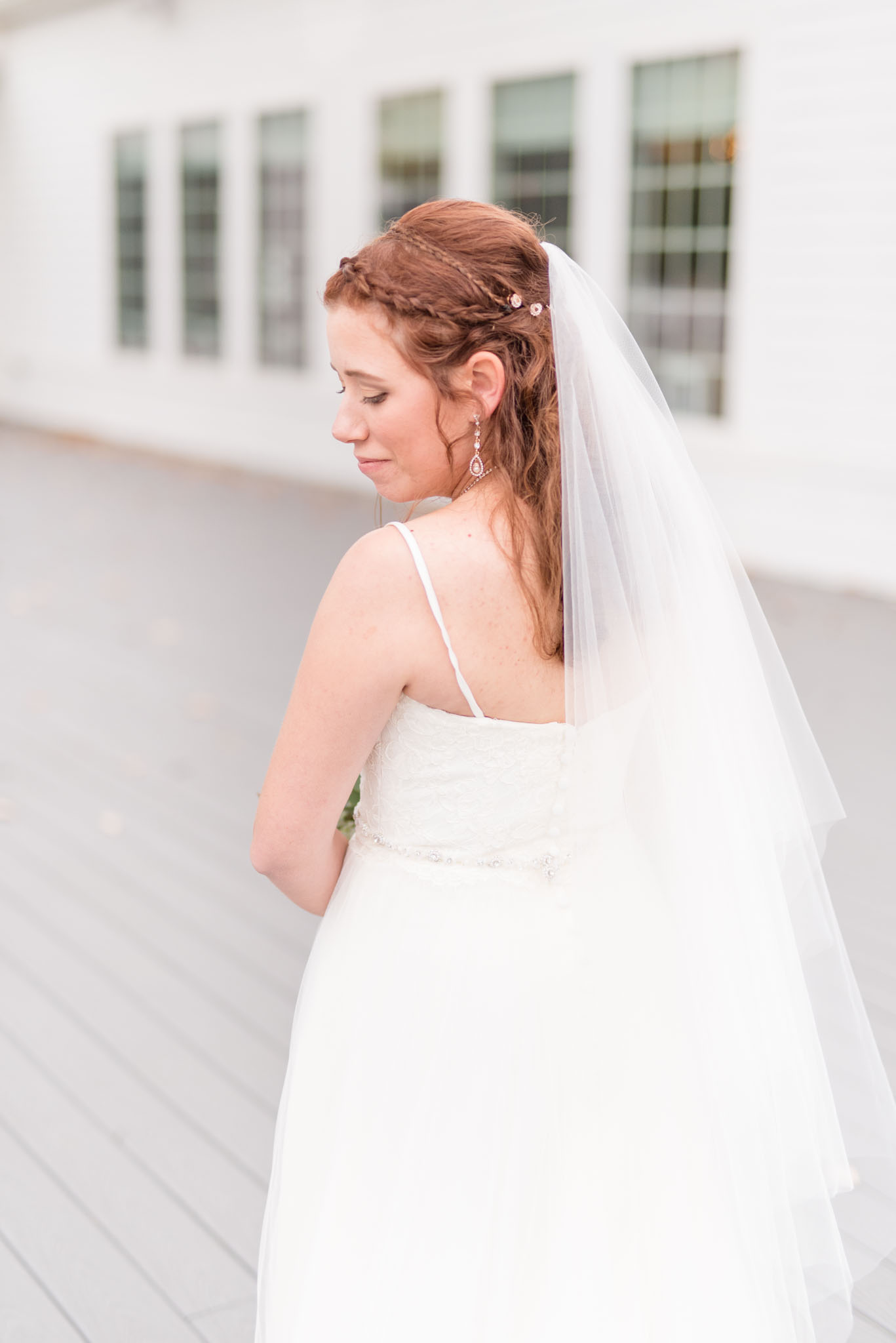 Bride looks over her shoulder.