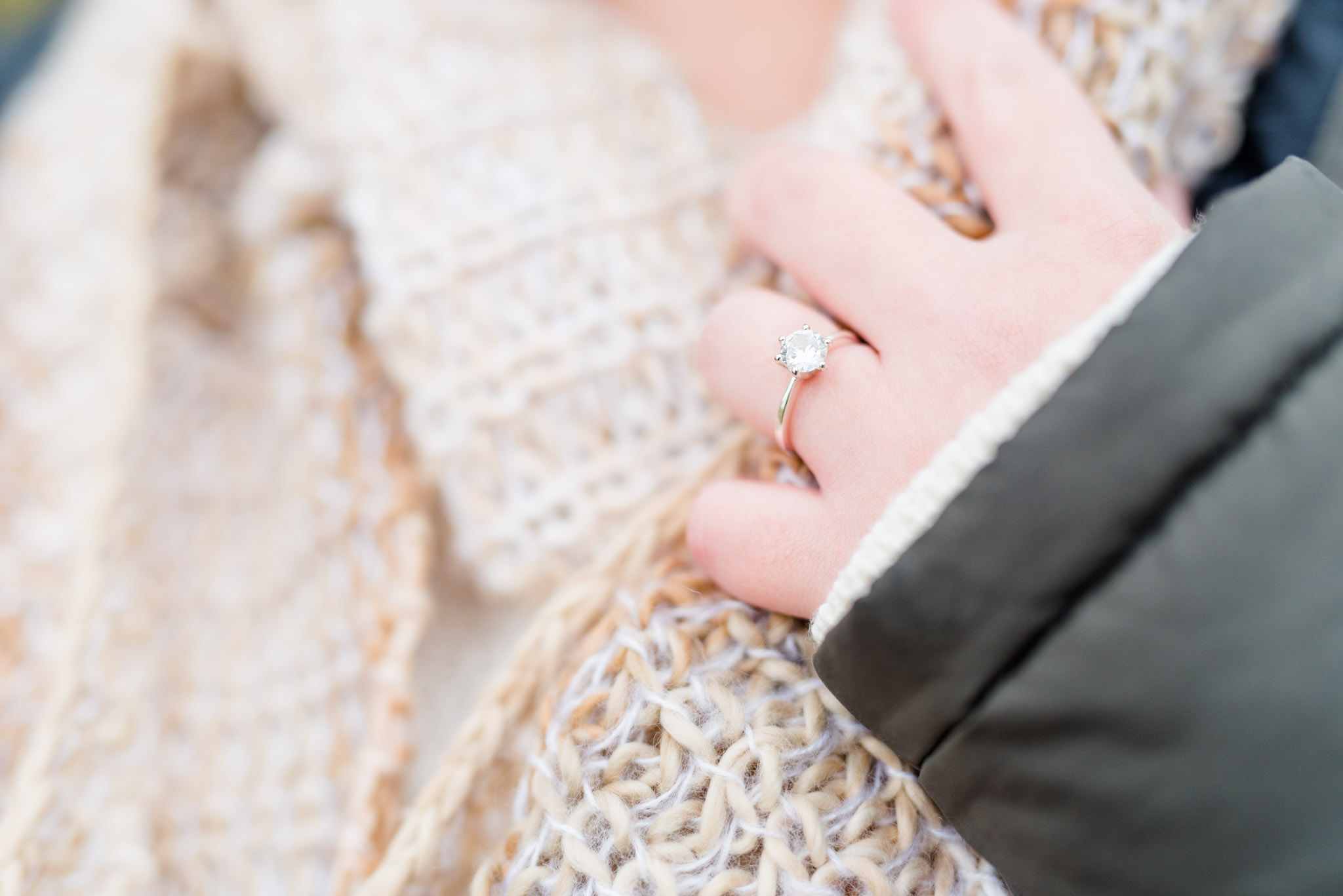 Close up of engagement ring and scarf during session.