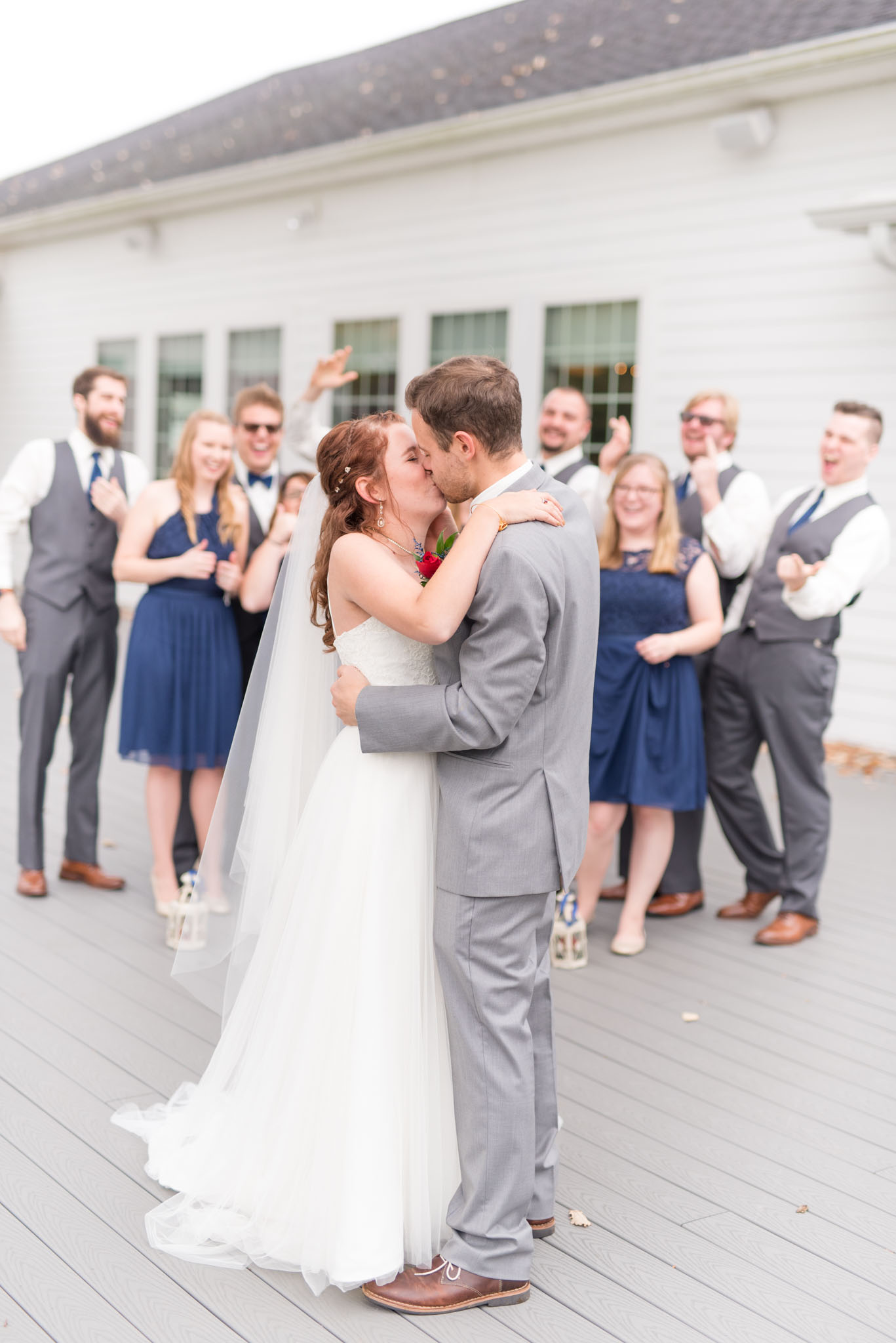 Bride and Groom kiss while the wedding party cheers!