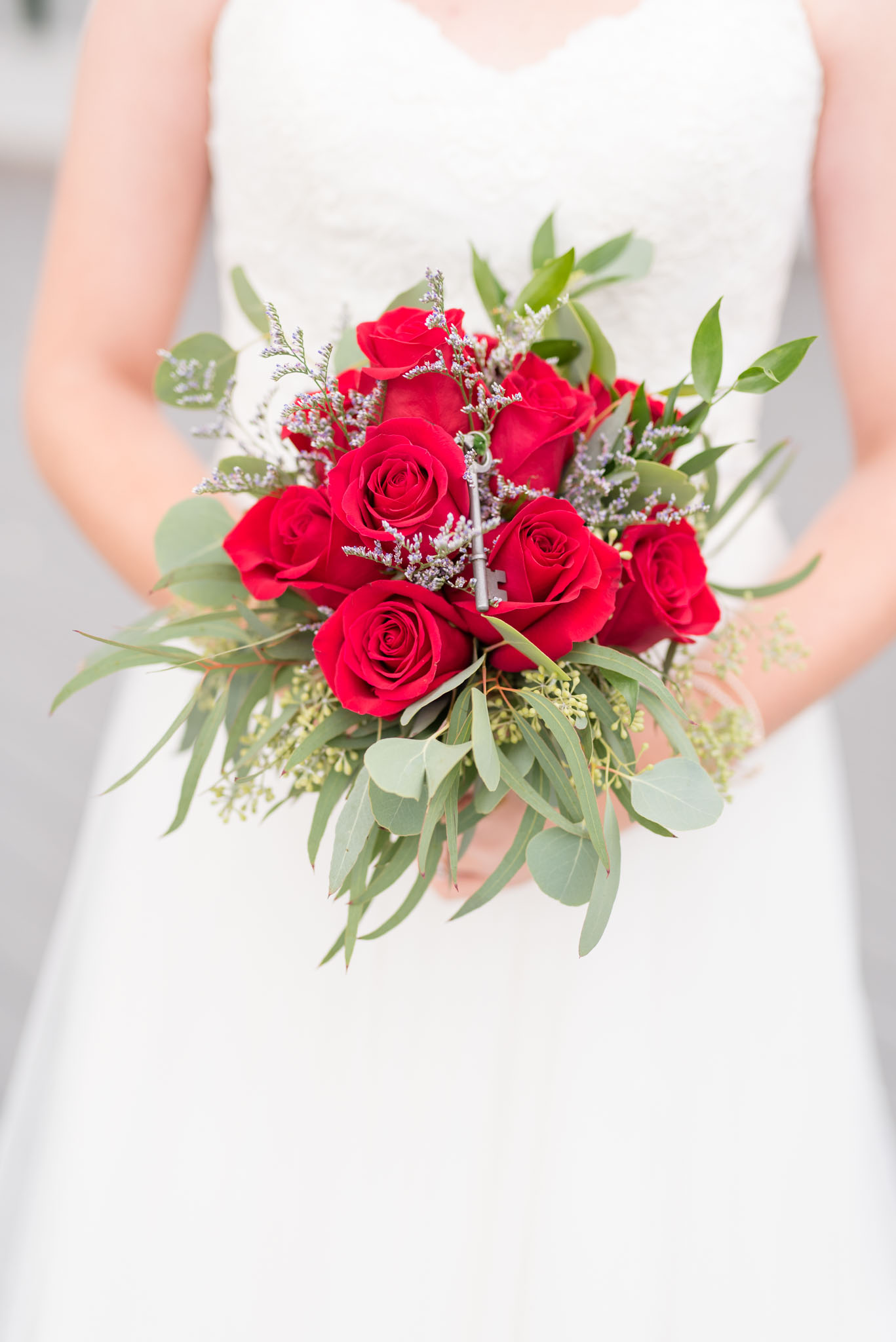 Bride holding Bouquet of Red Roses