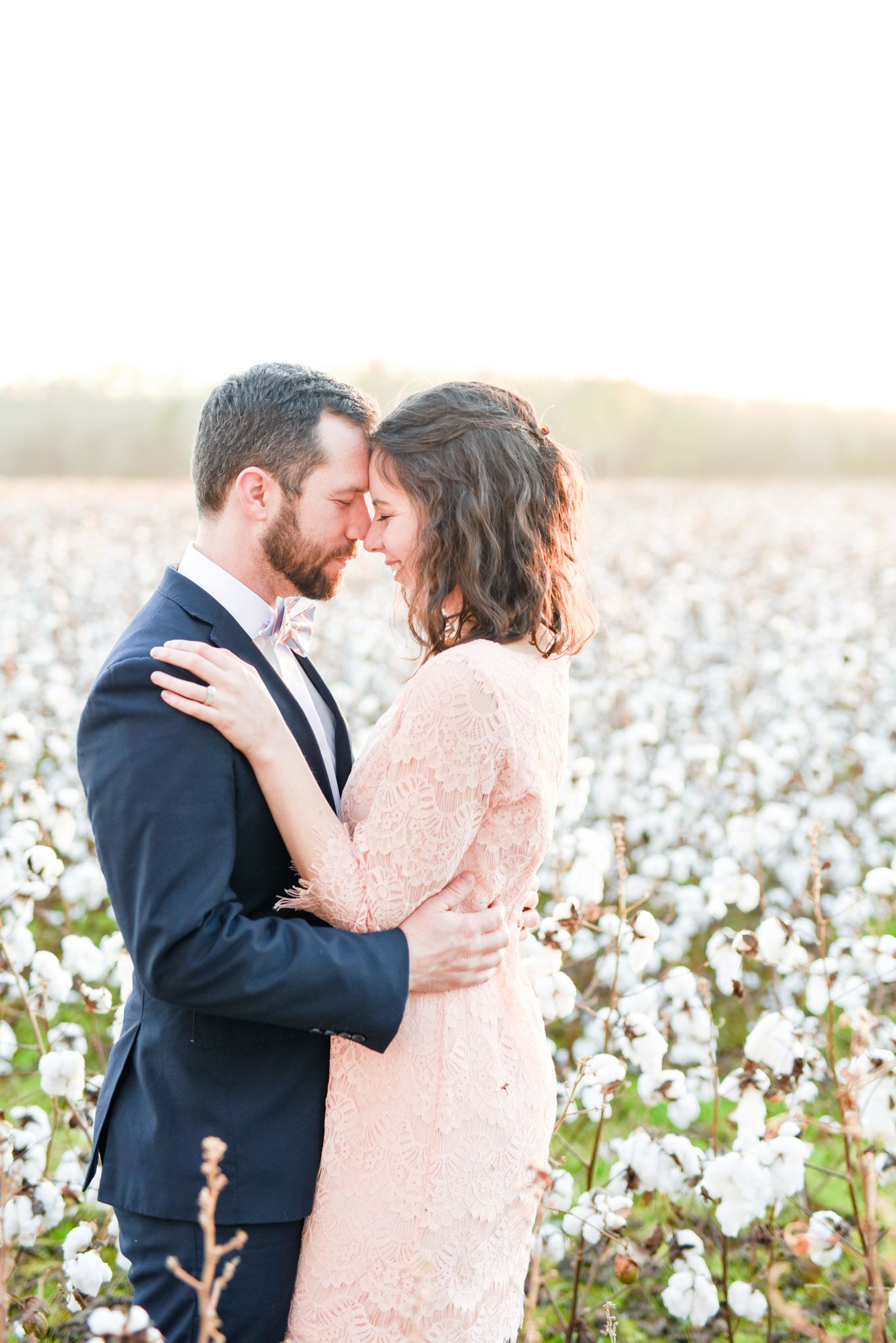 Couple in cotton field at sunset.