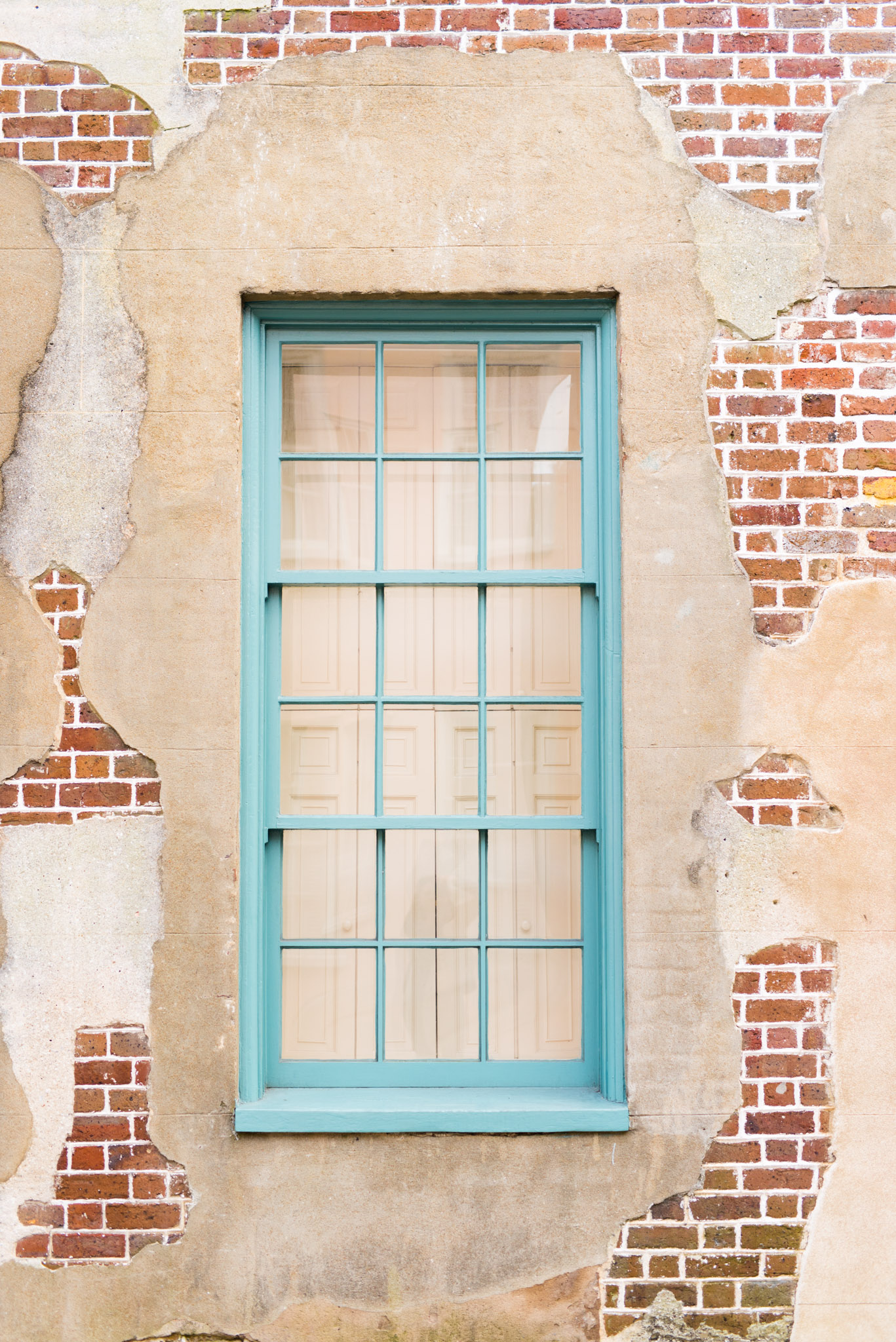 blue window in old brick building