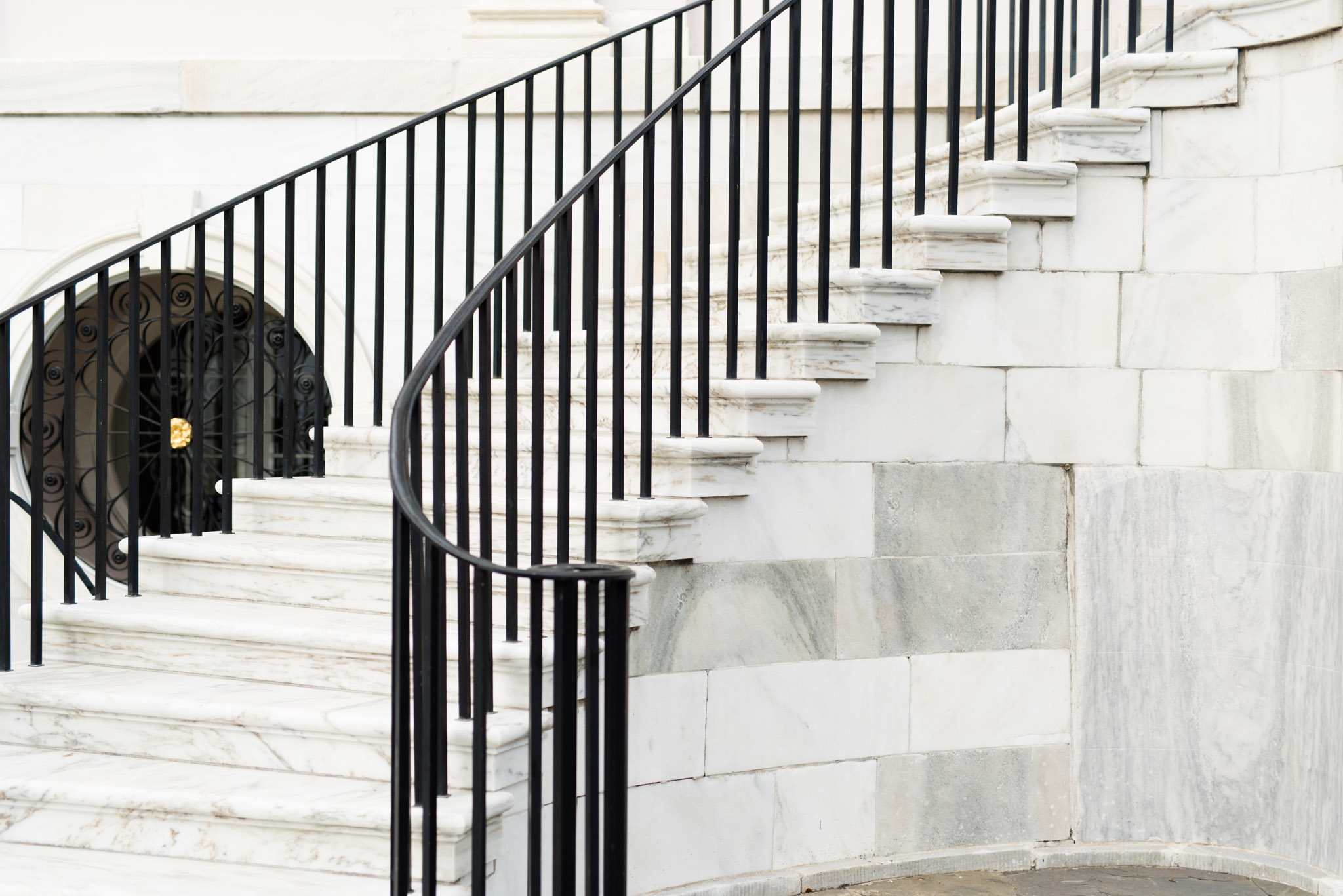 Marble staircase with black iron railing