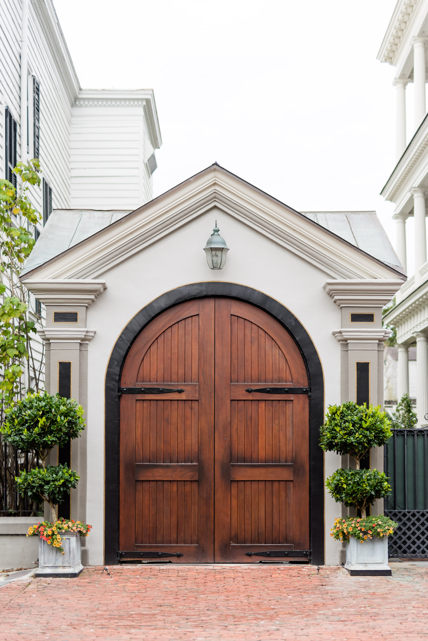 large wooden doors on white building