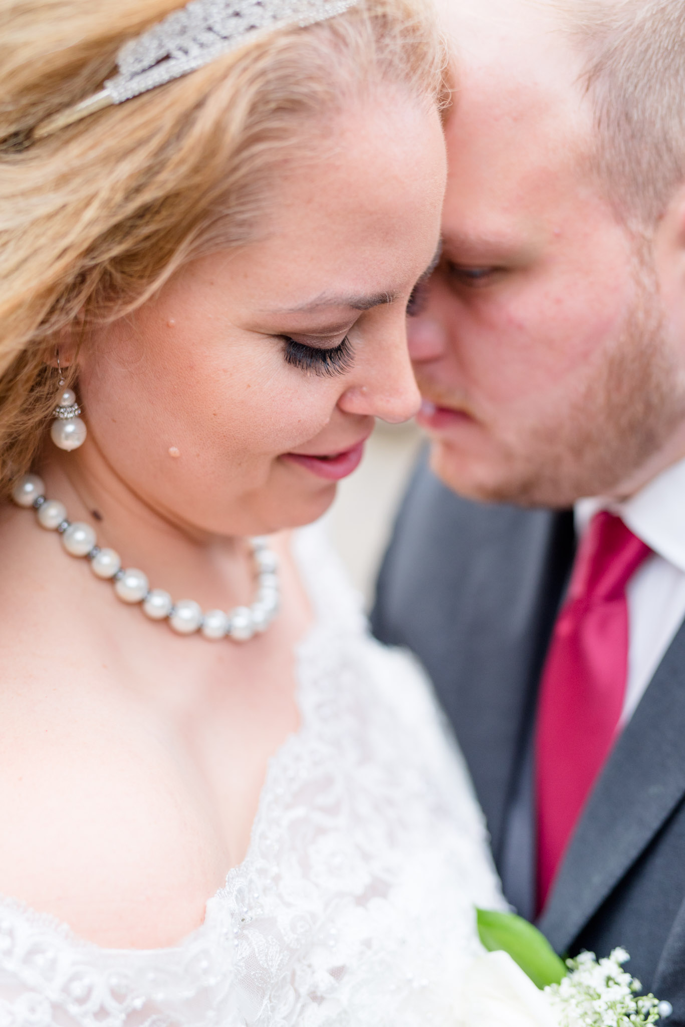 Bride and Groom snuggle during wedding portraits