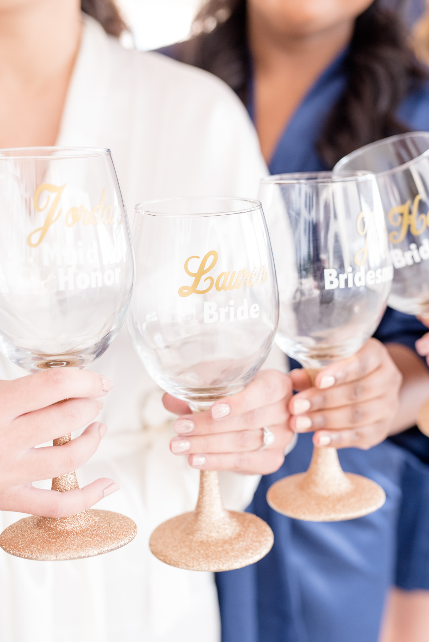 Bridal party holds personalized wine glasses