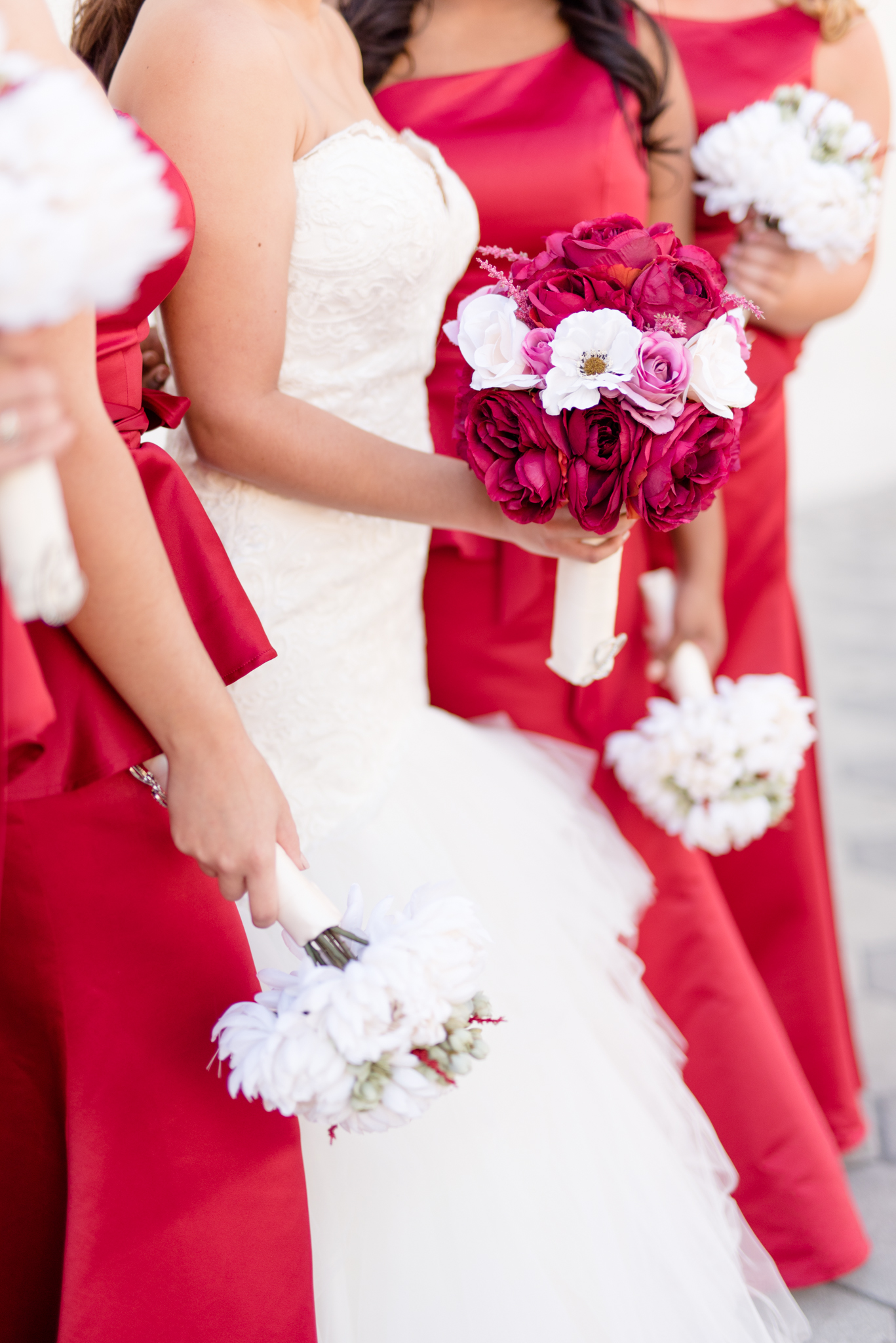 Bride and Bridesmaids hold boquets.