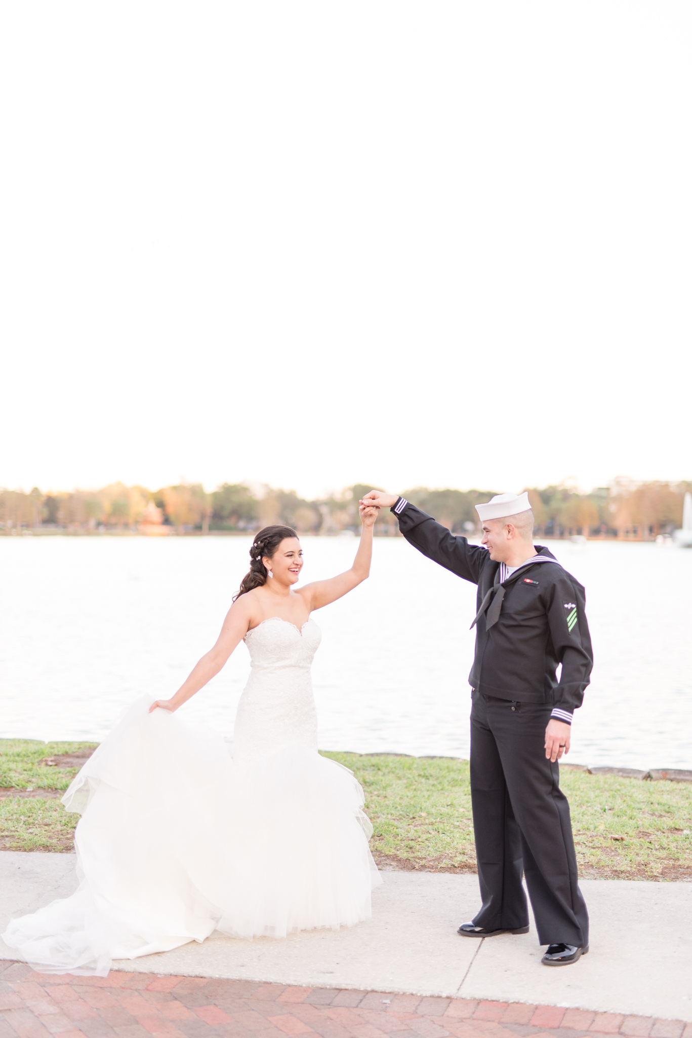 Groom Twirsl bride beside Lake Eola