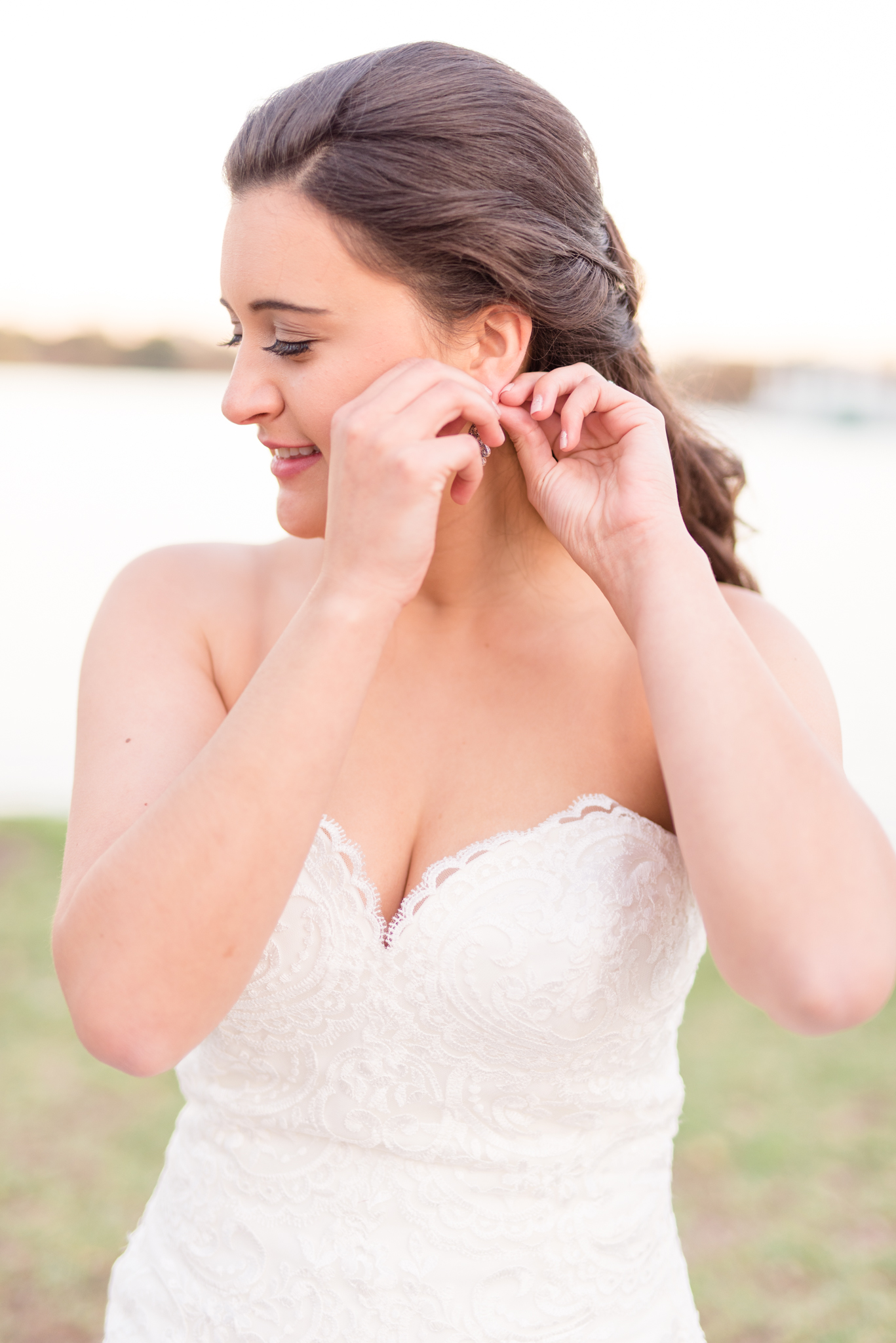 Bride puts in earring on wedding day.