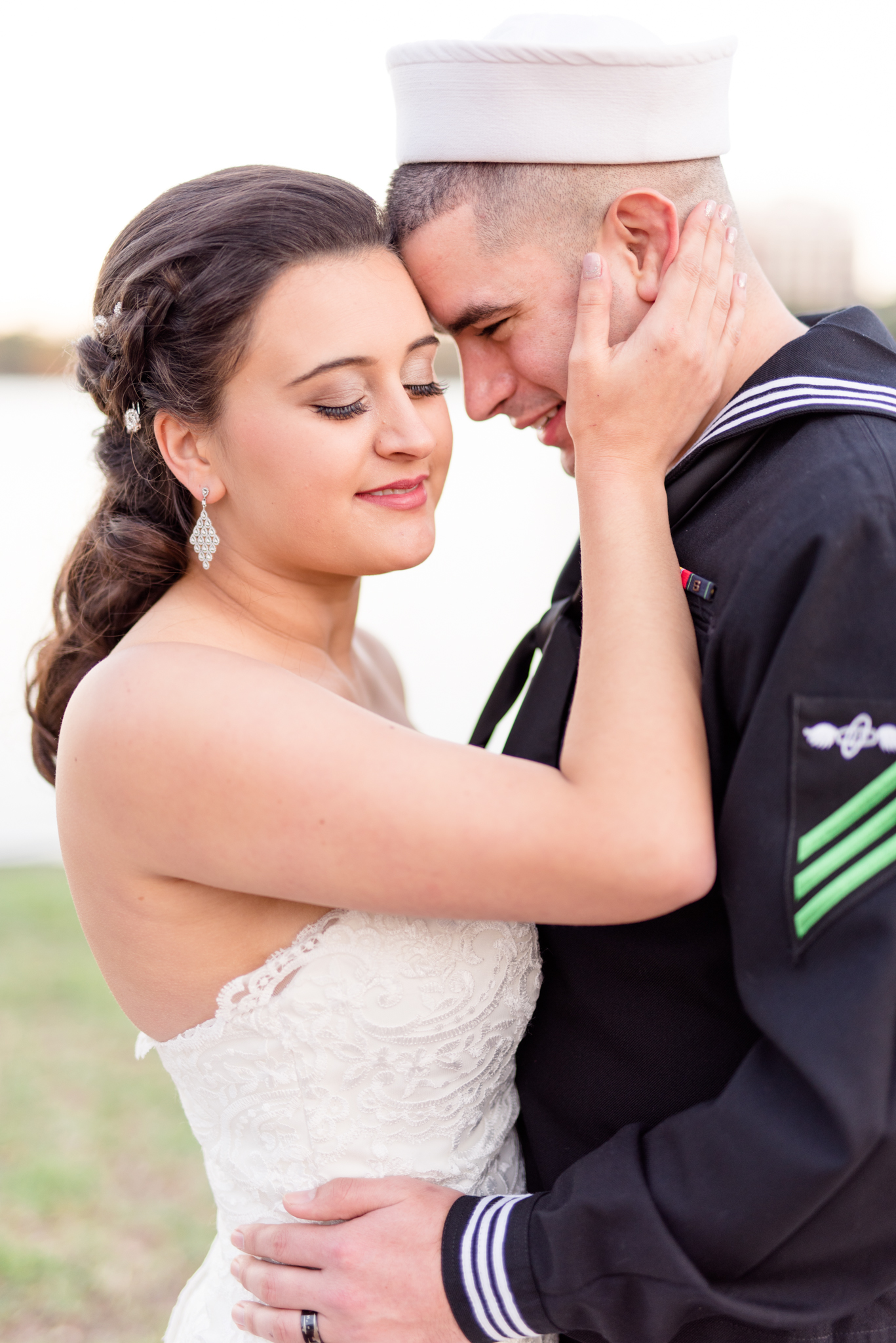 Bride and groom snuggle during wedding pictures
