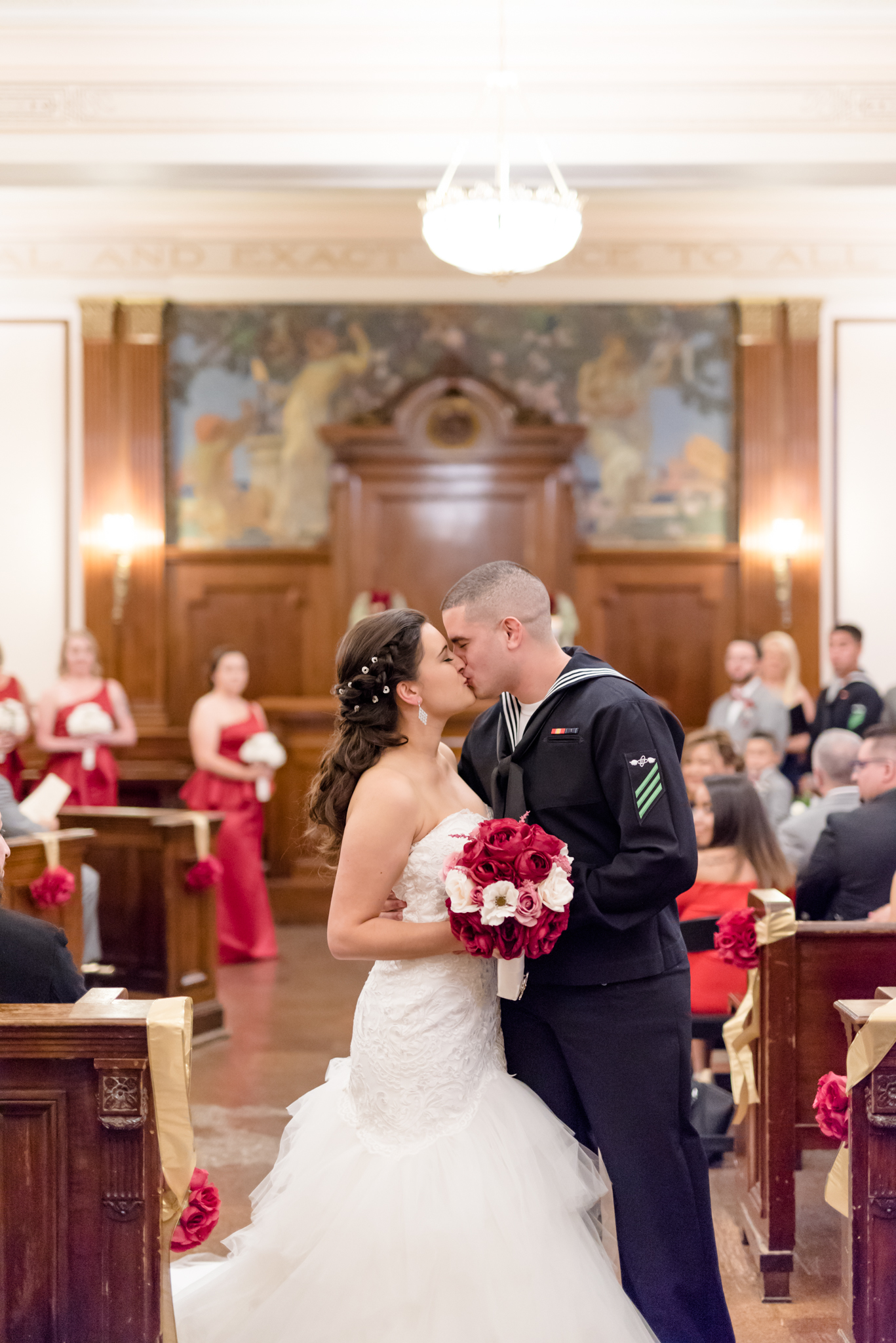 Bride and groom kiss as they leave wedding ceremony.