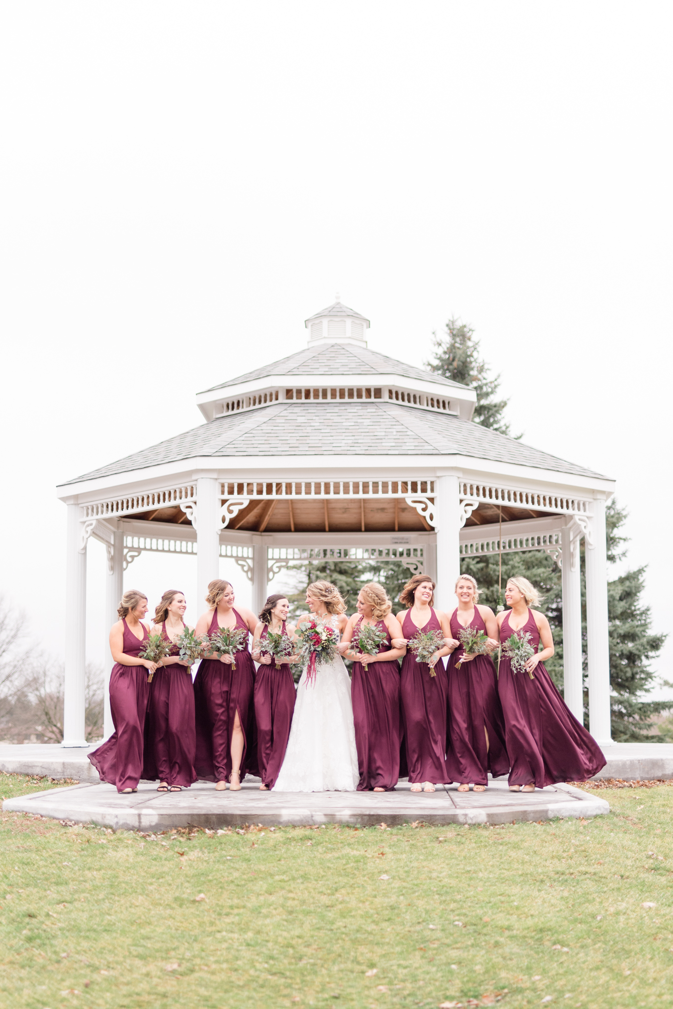 Bridal Party walks in front of gazebo.