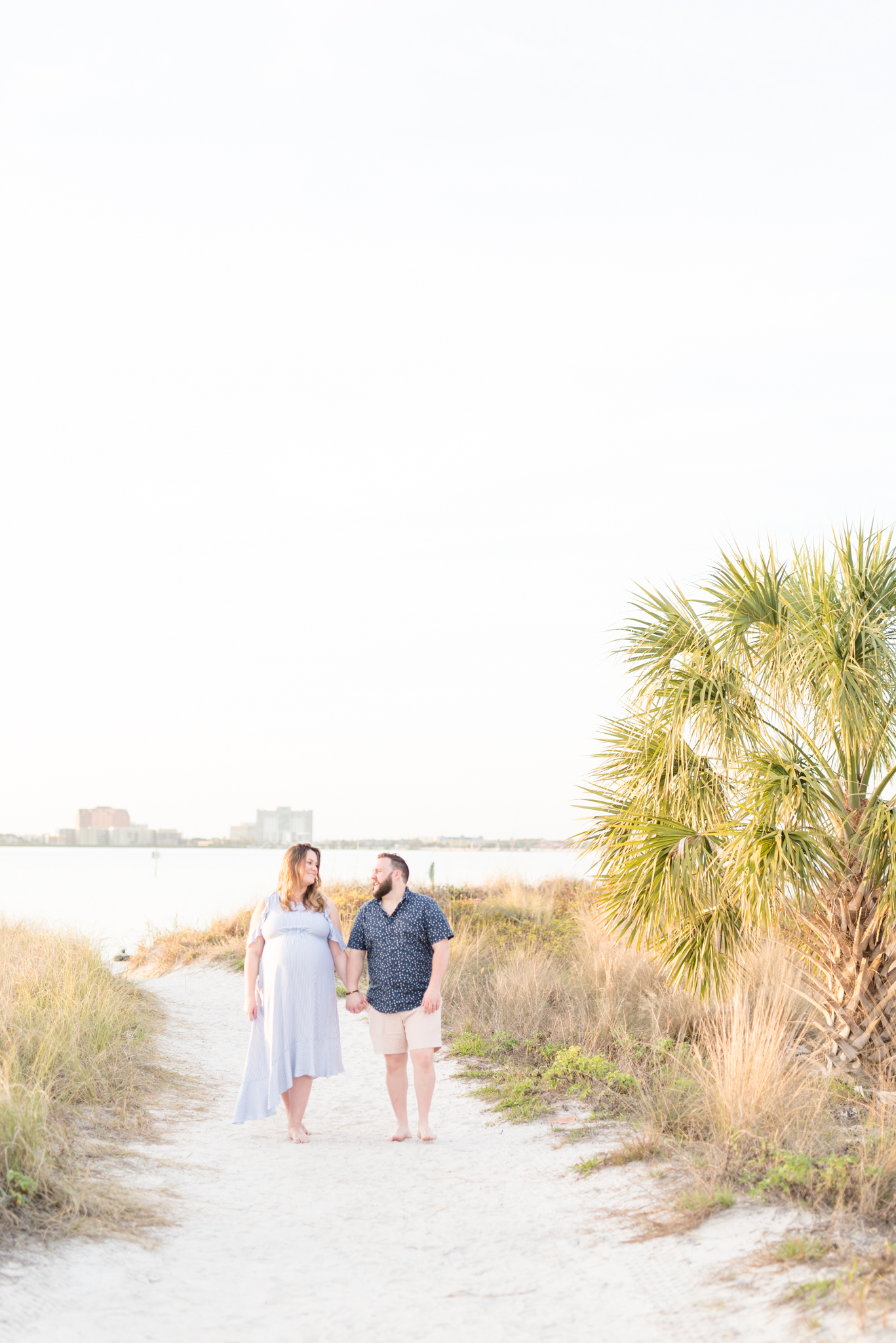 Couple walks along beach pathway at Cypress Point Park