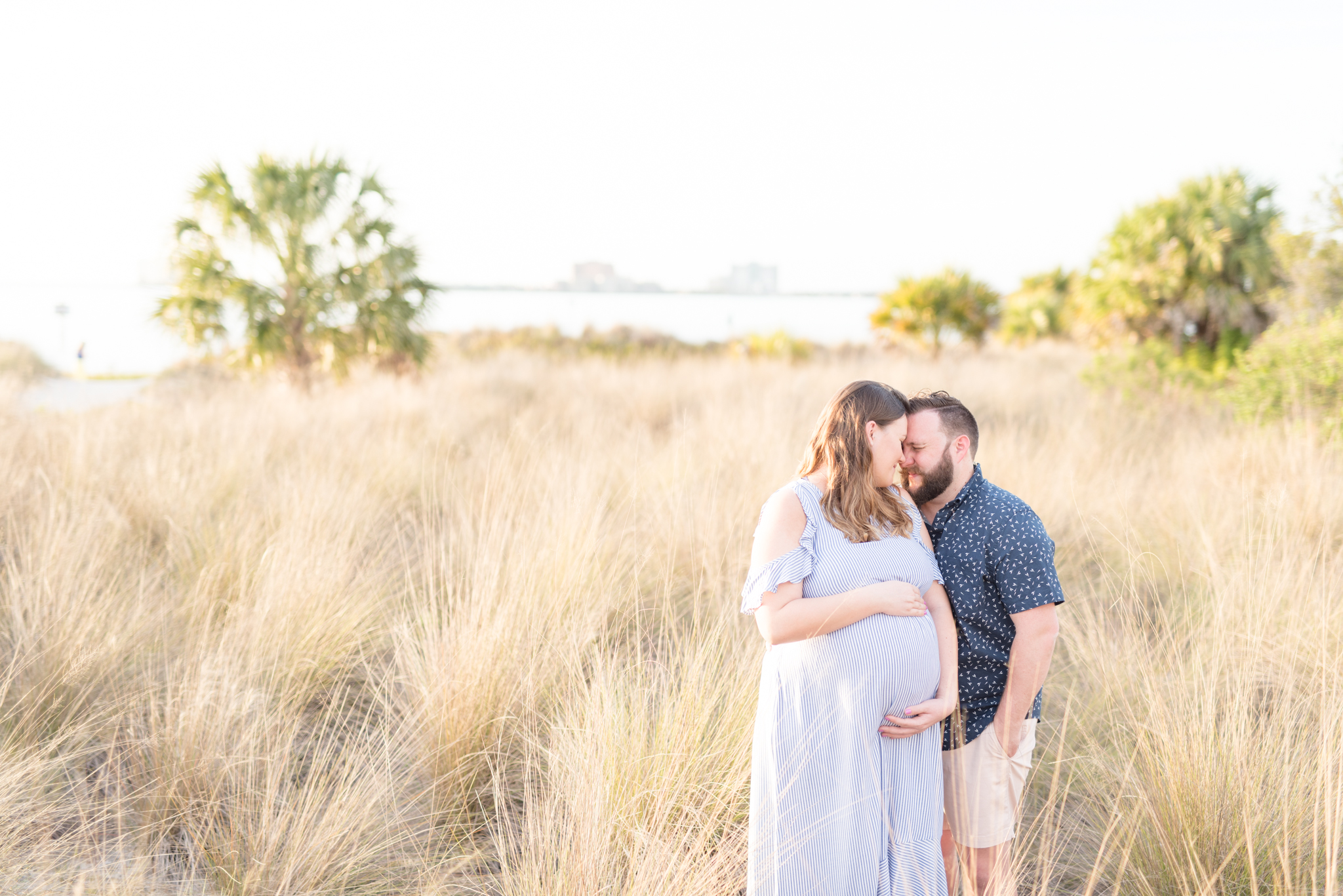 Couple snuggles at Cypress Point Park Maternity Session