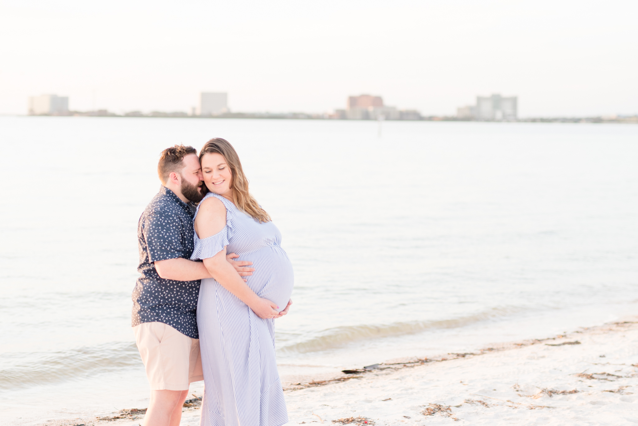 Tampa couple snuggles during Cypress Point Park Maternity Pictures