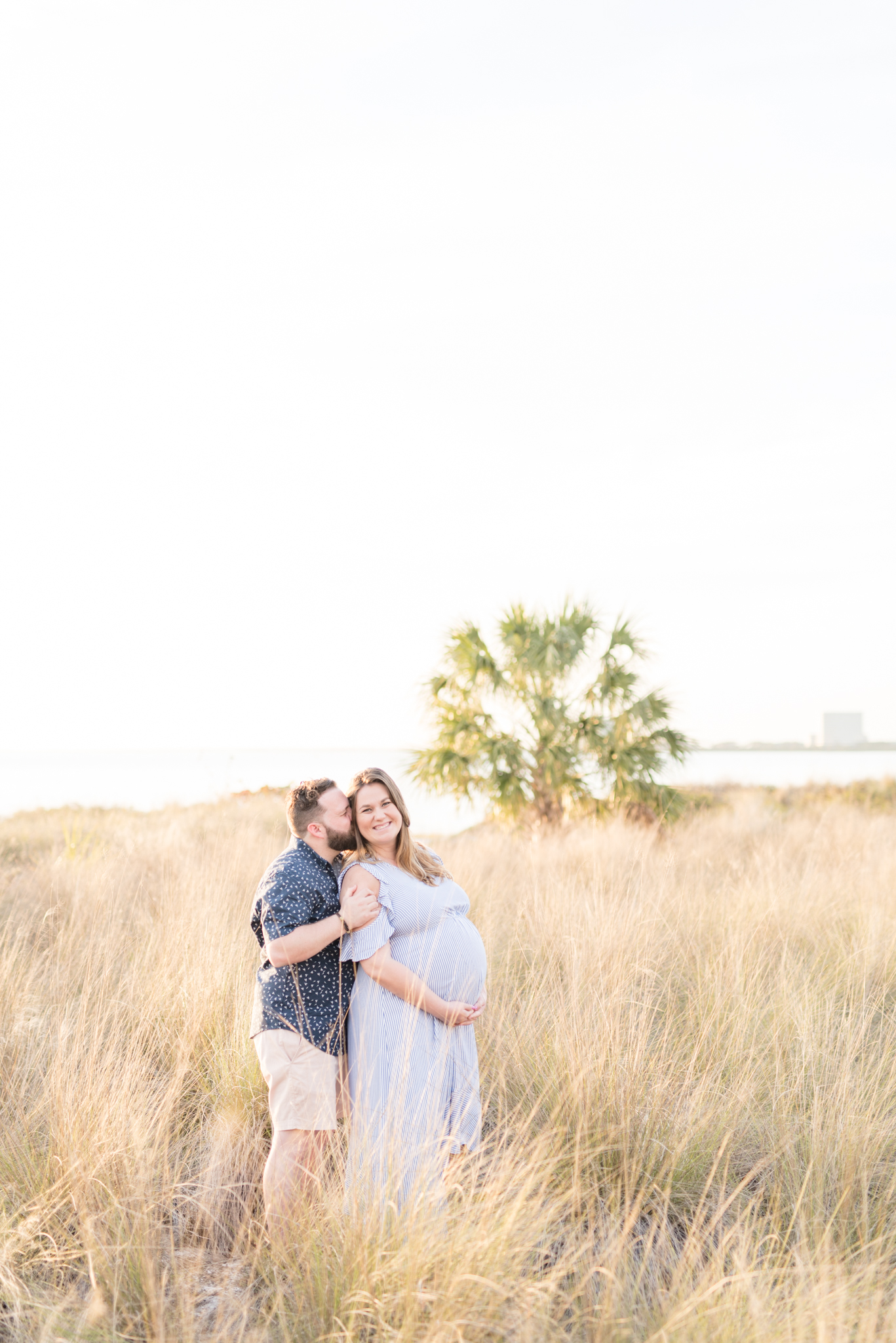 Tampa Couple laughs during Cypress Point Park Maternity Pictures