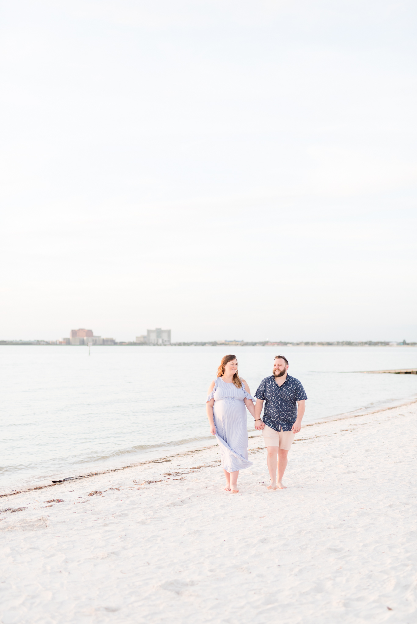 Couple walks along Tampa Beach Maternity Pictures