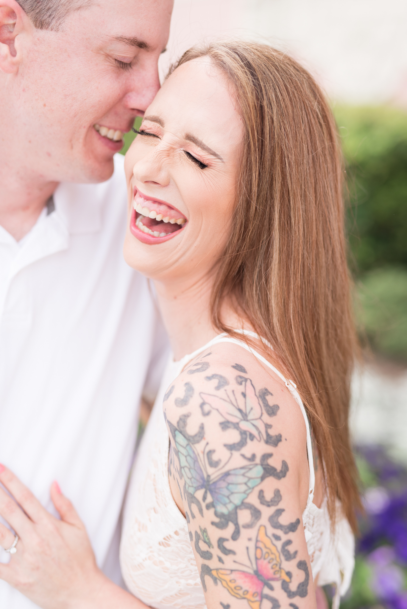 Woman laughs while hugging her fiance.