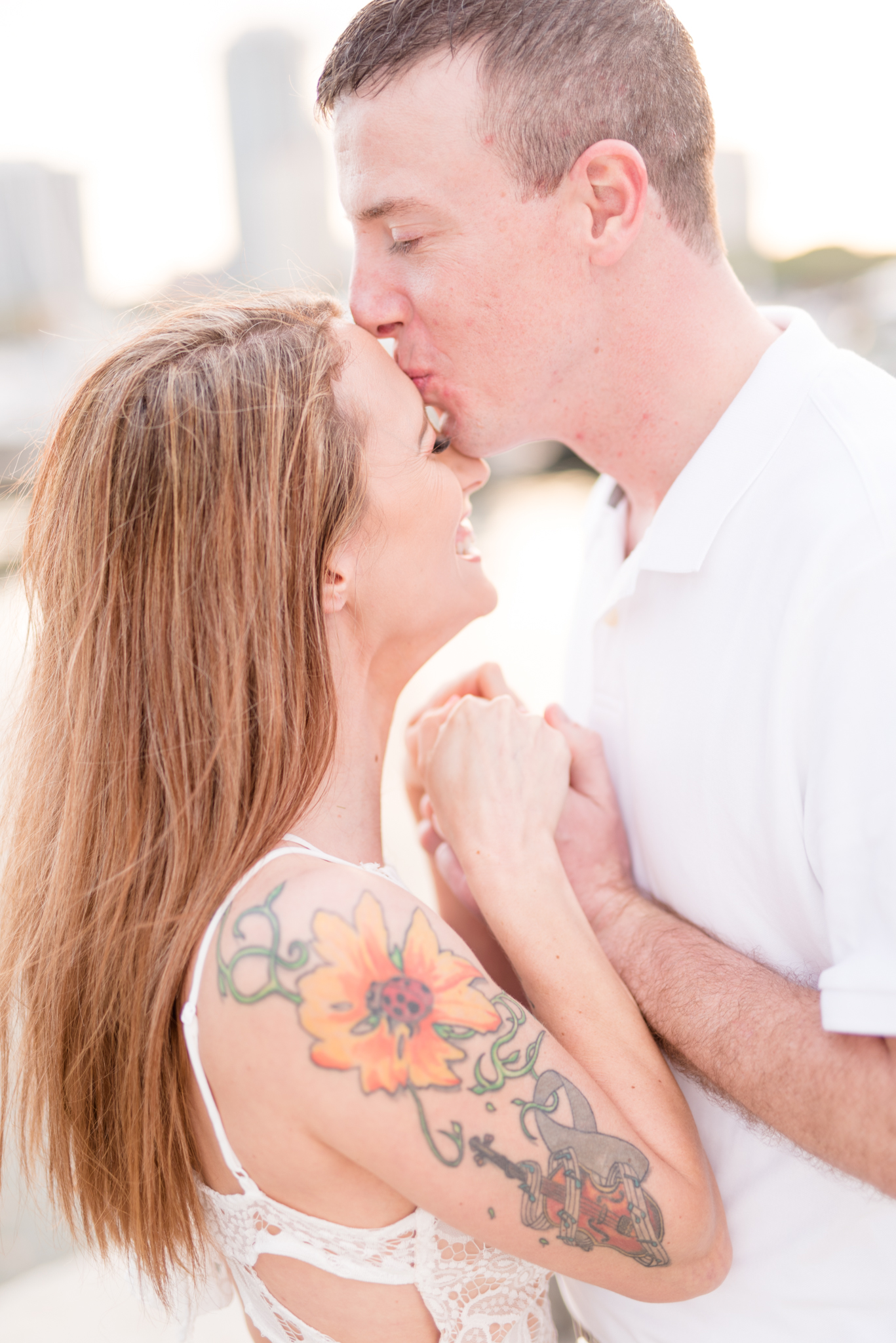 Man kisses fiances forehead in St. Petersburg, Florida.