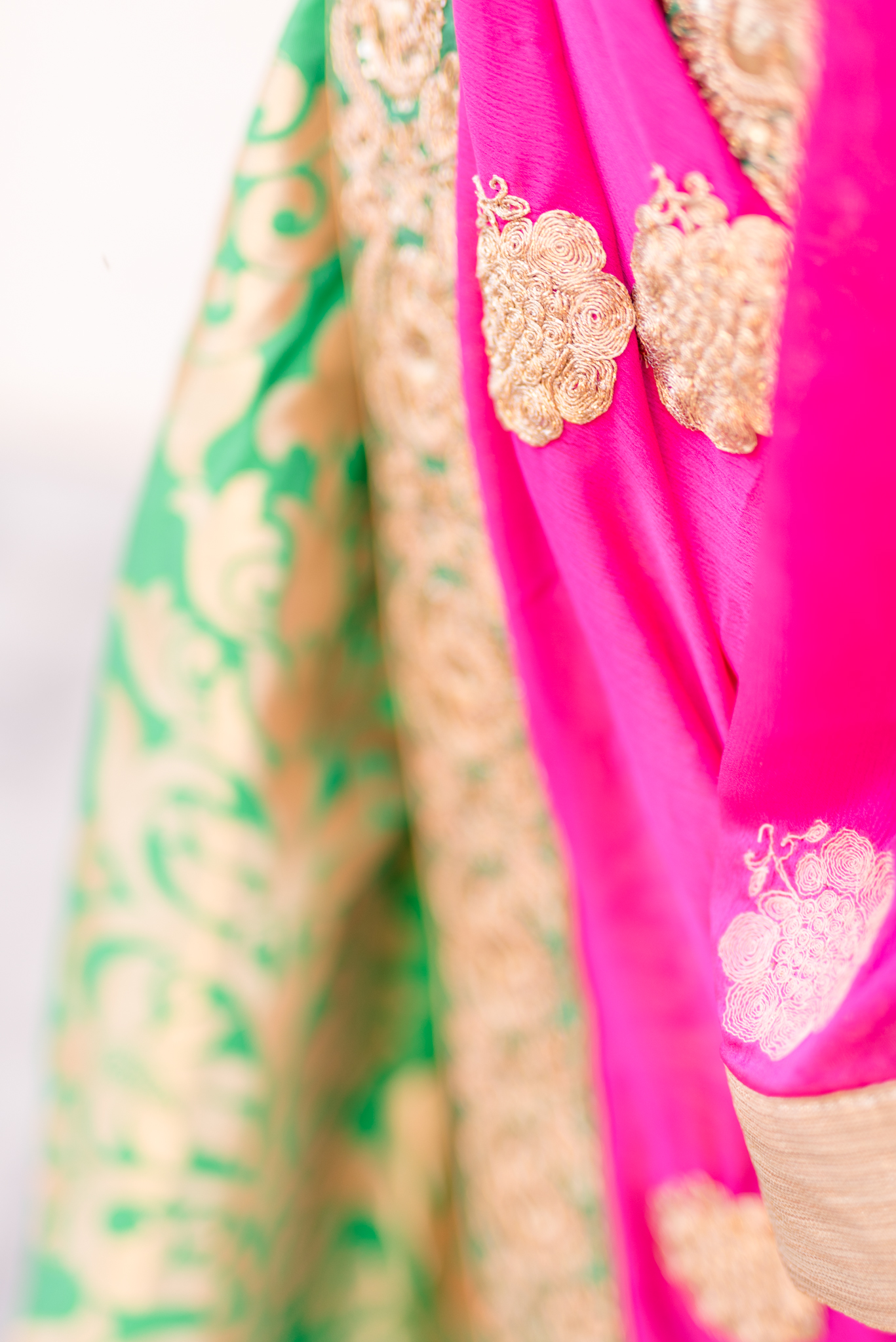 Details on woman's traditional Indian outfit.