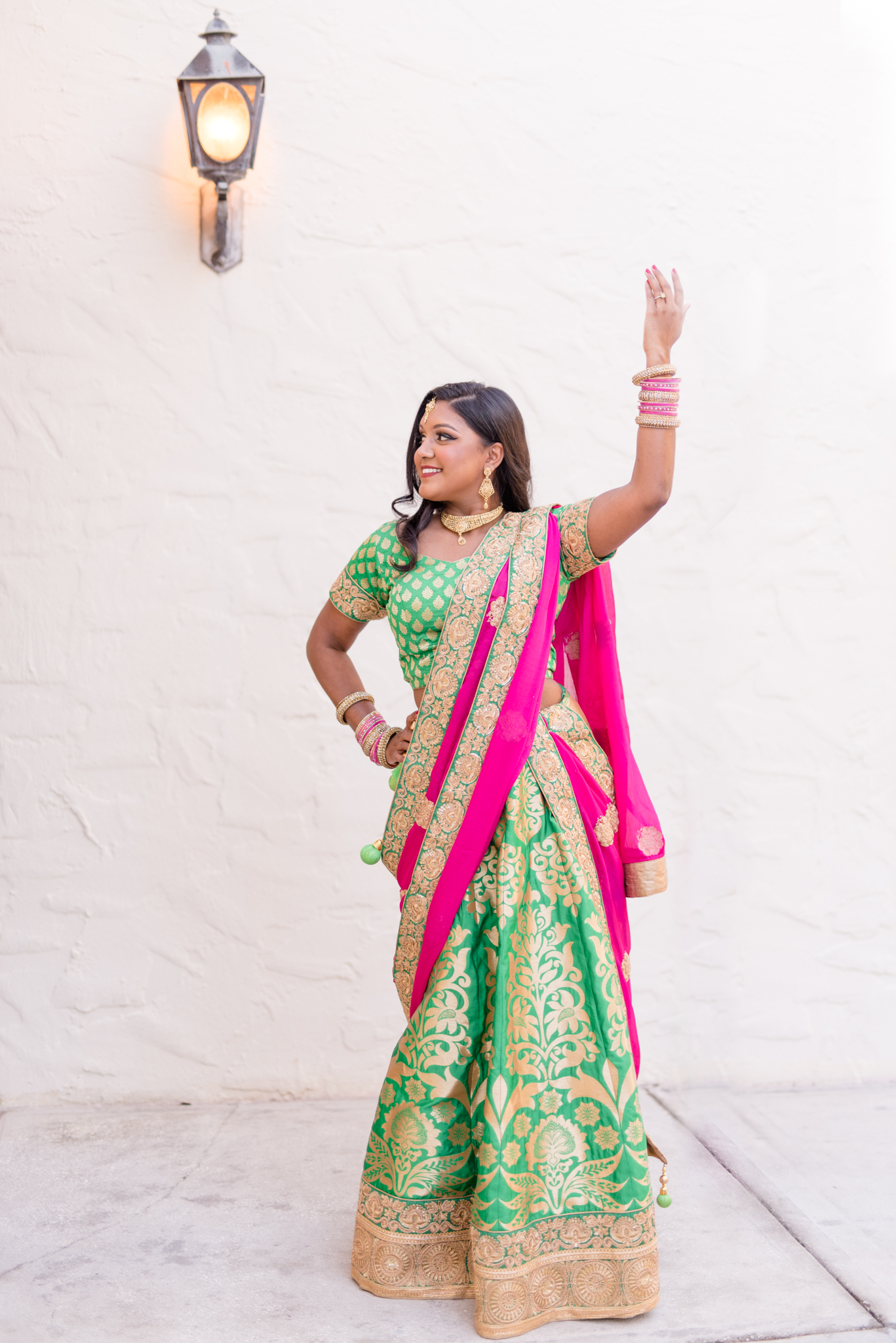 Woman poses in traditional Indian outfit.