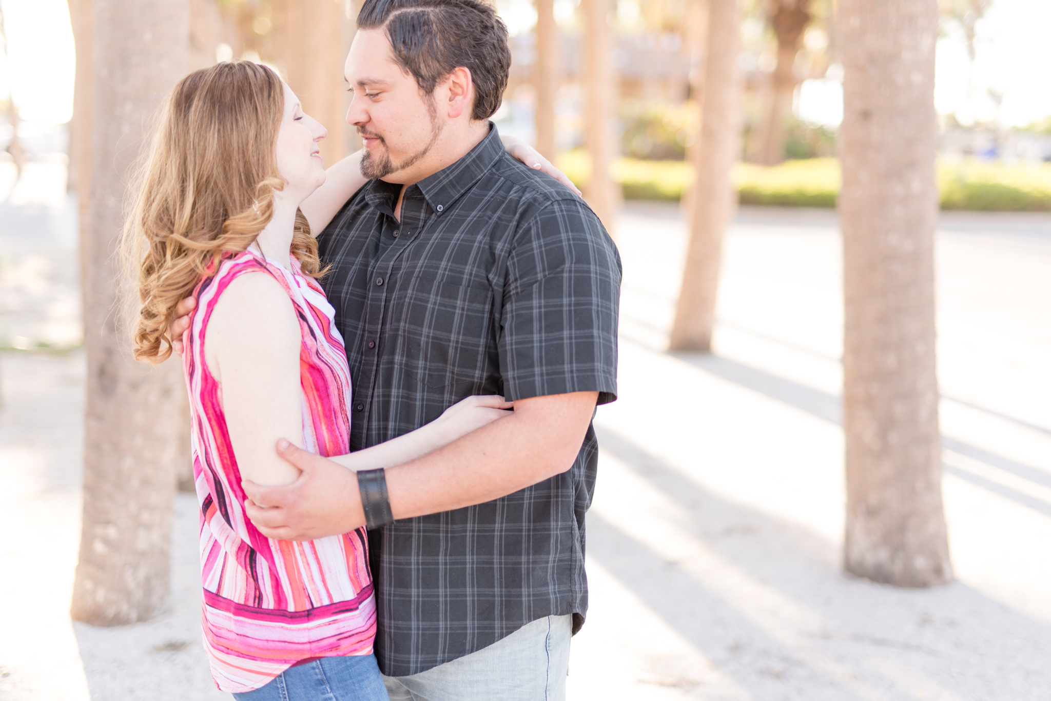 Engaged couple laugh together.