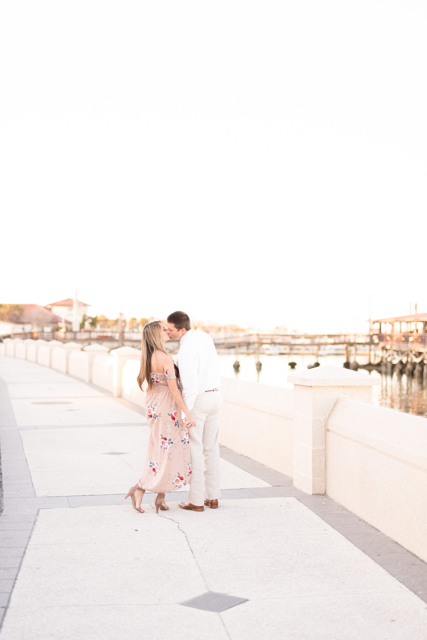 Couple kisses on St. Augustine boardwalk.
