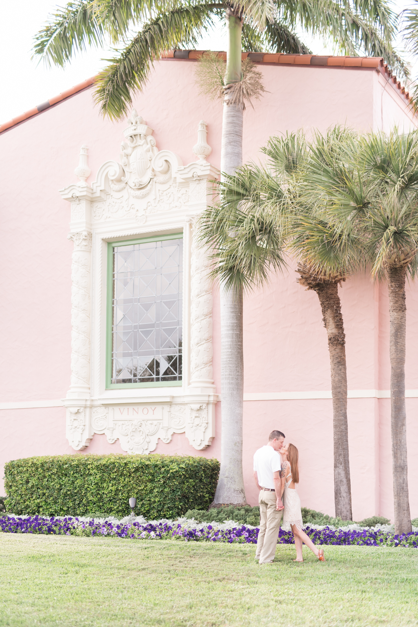 Engaged couple kiss in front of The Vinoy Renaissance hotel.