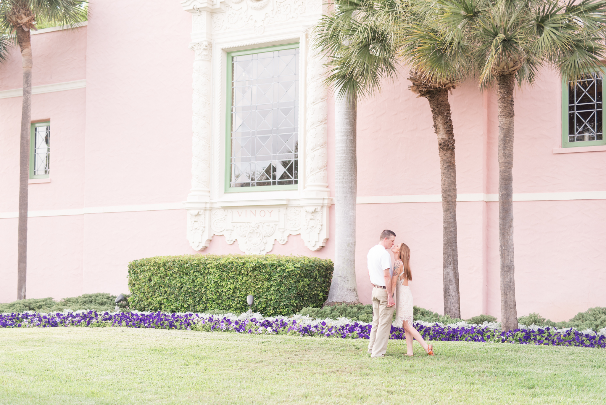 Couple leans in for a kiss in front of The Vinoy Renaissance Hotel.