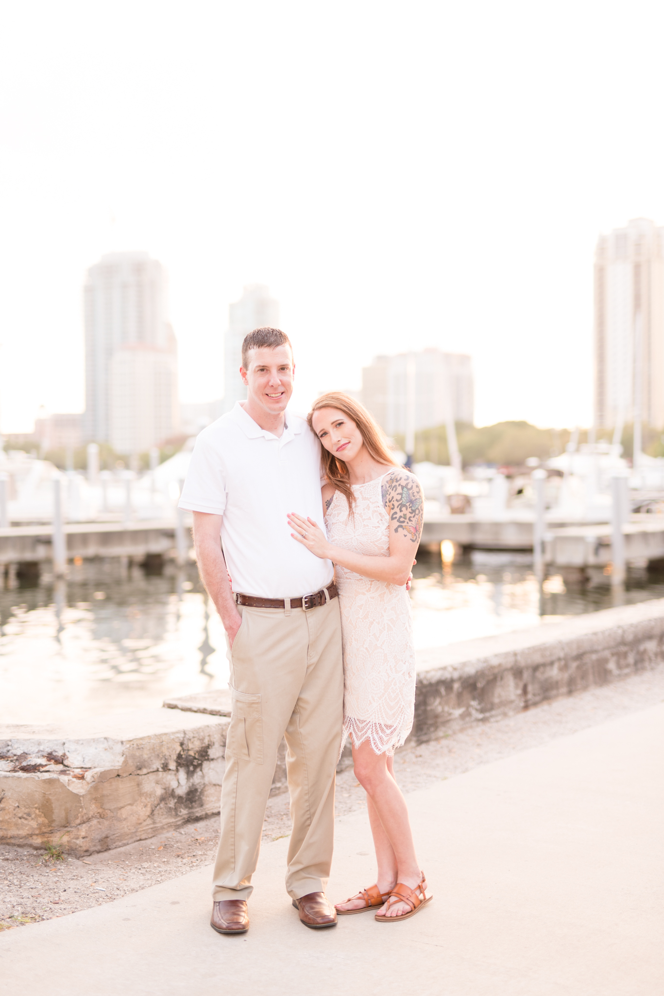 Engaged couple smiles at the camera.