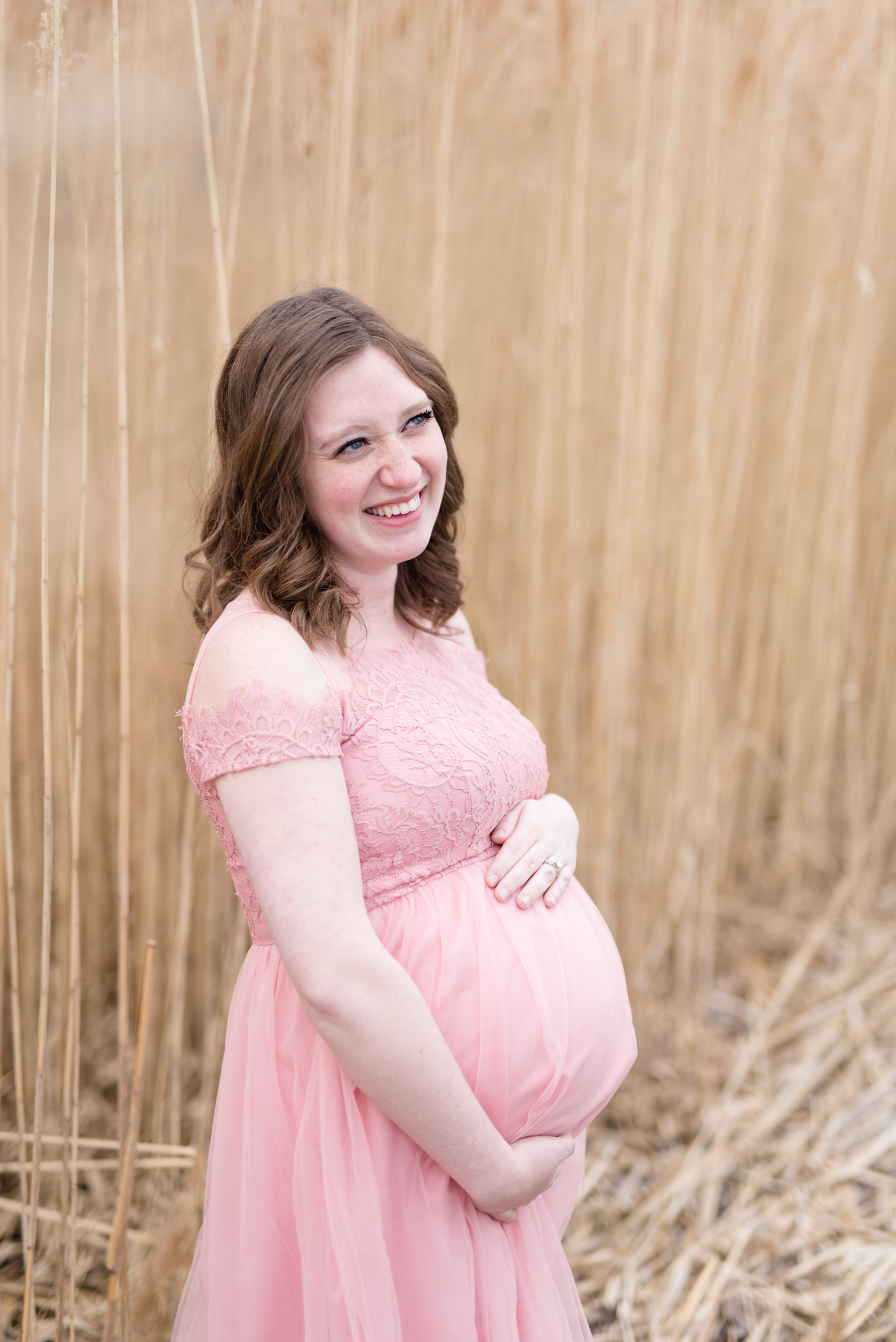 expecting mother smiles off camera