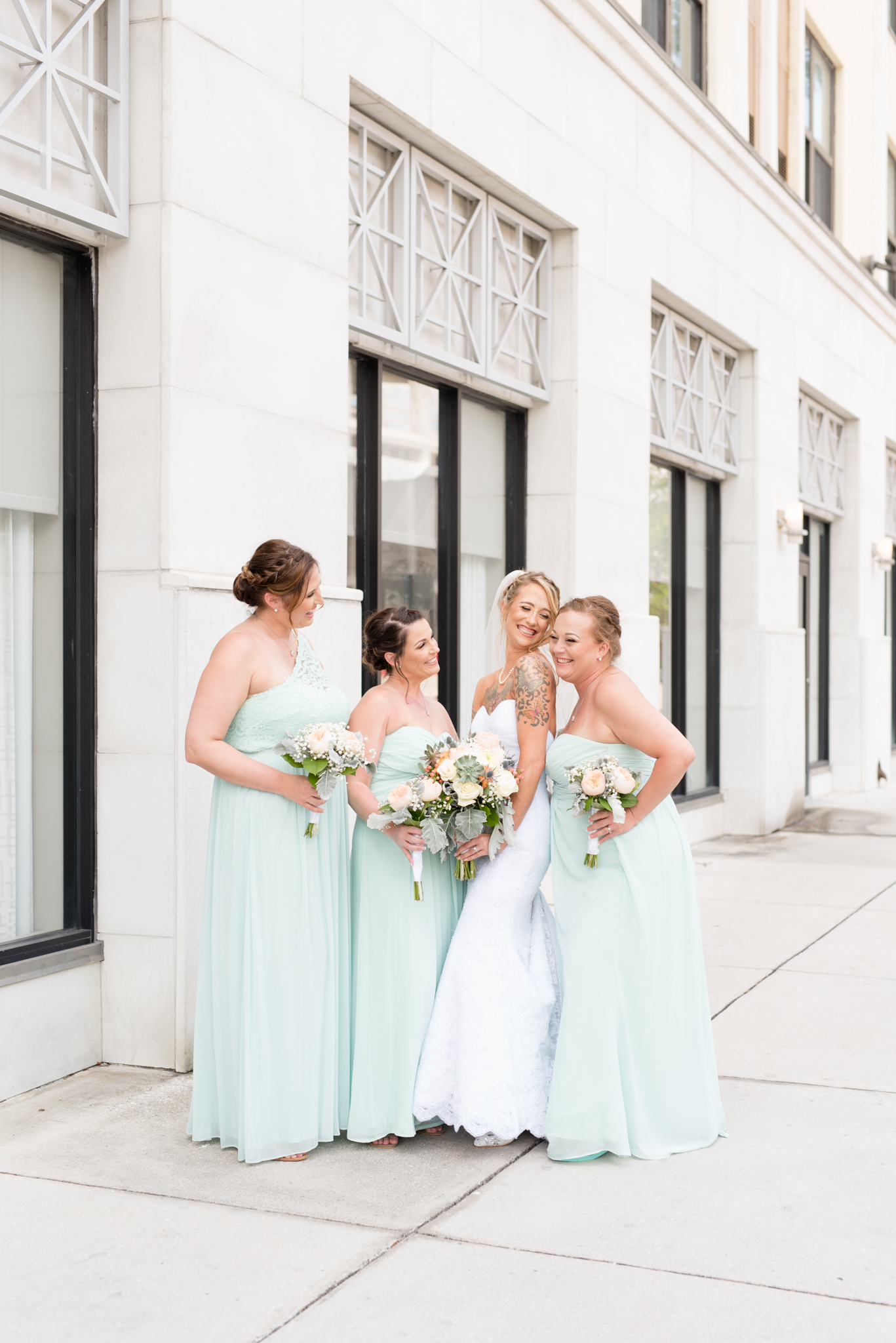Bridal party smiles together on St.Petersburg street.
