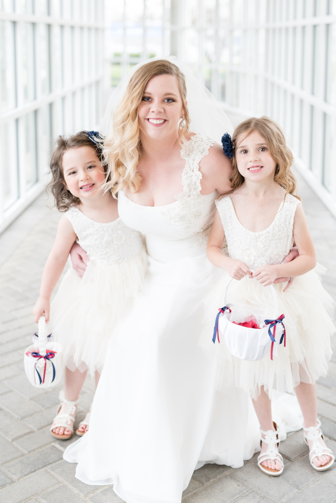 Bride poses with flower girls.