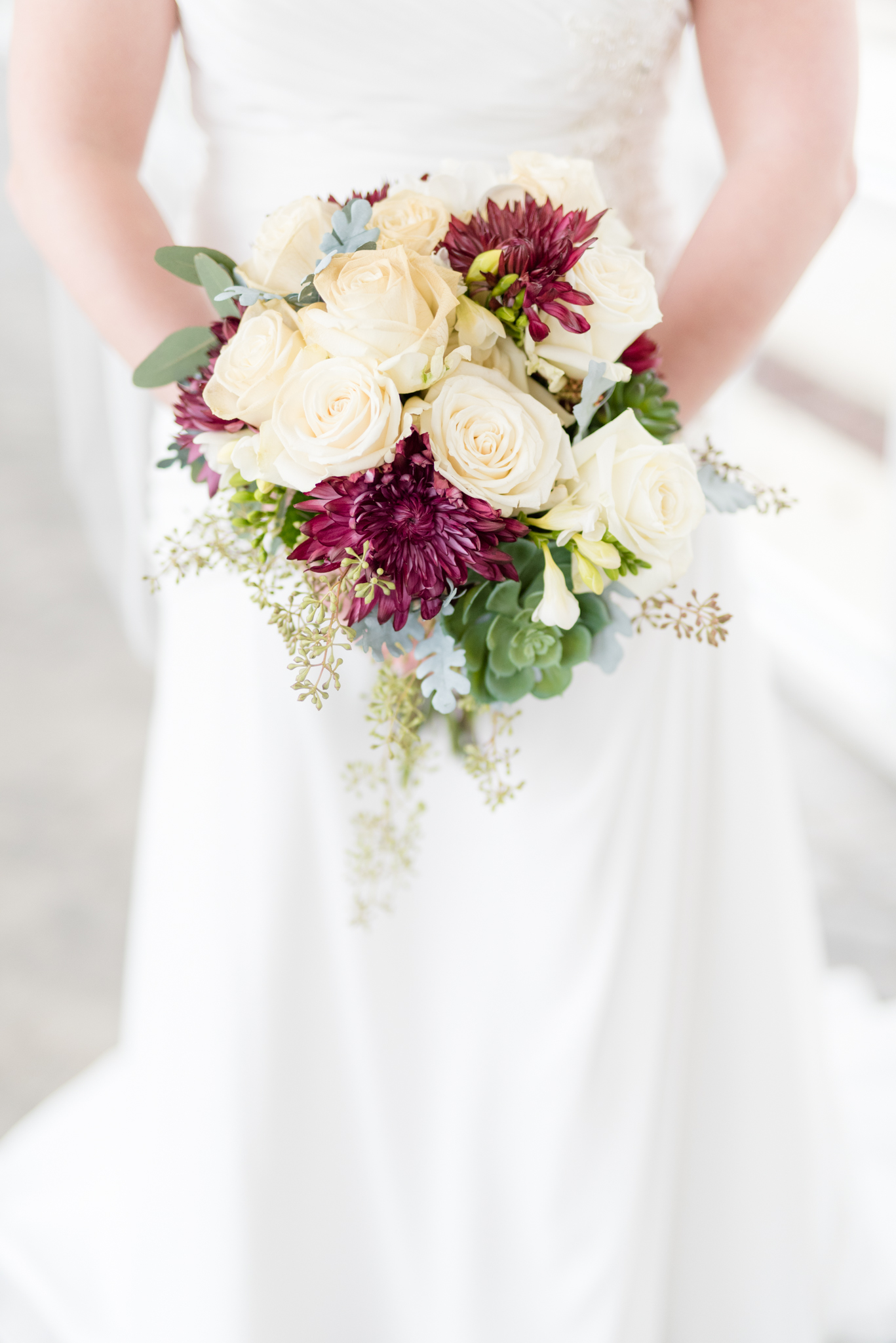 Bride holds Bridal bouquet.