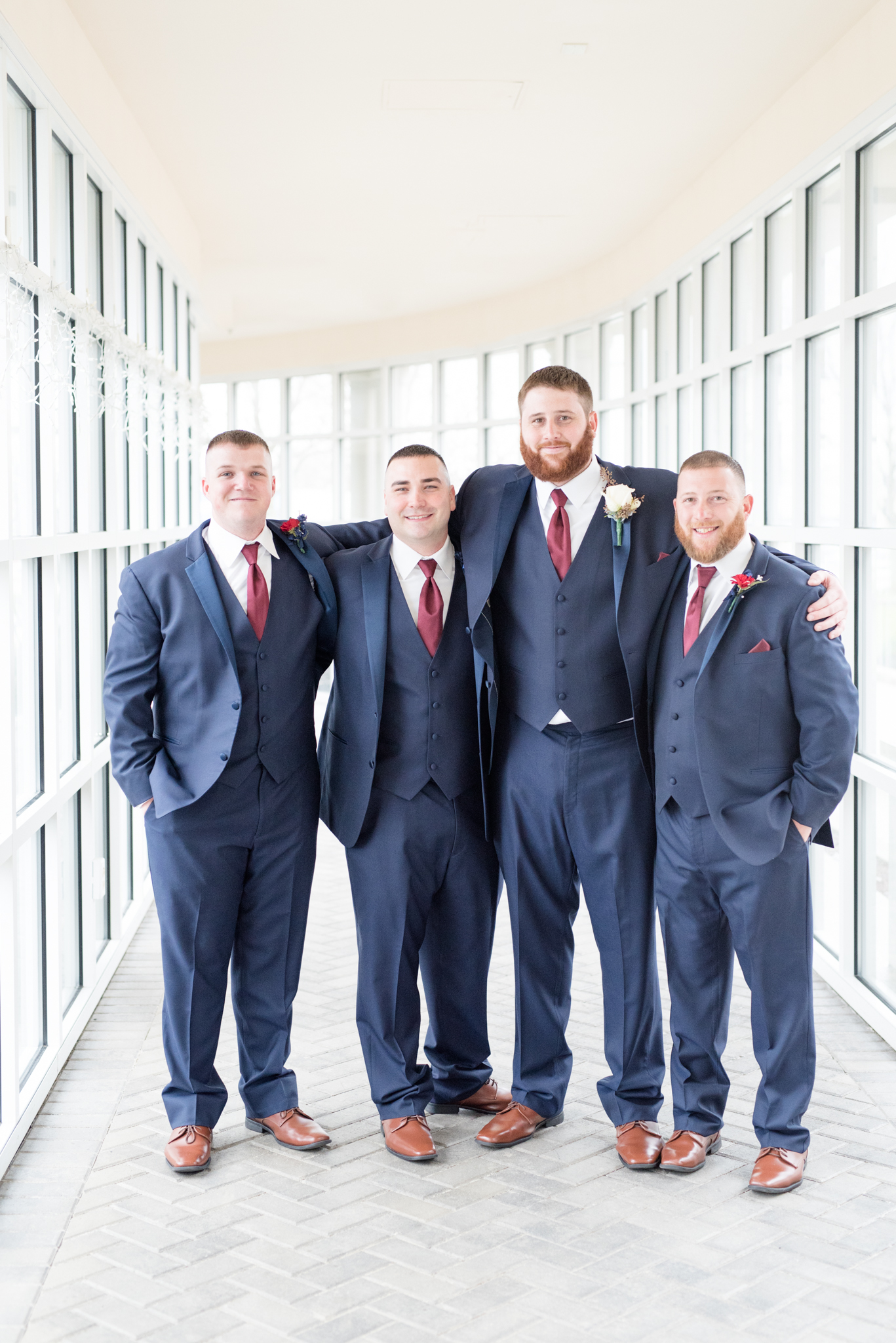 Groom's party hugs each other.