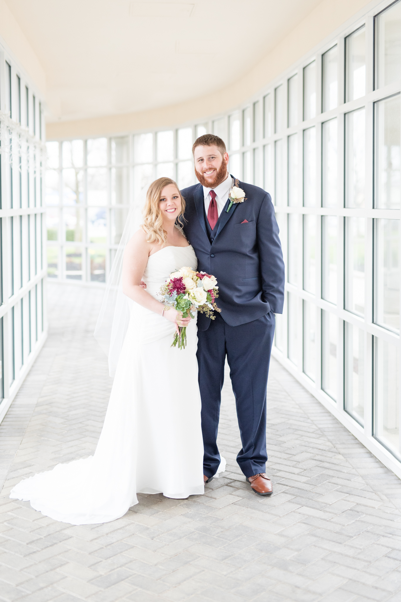 Bride and groom smile at camera.