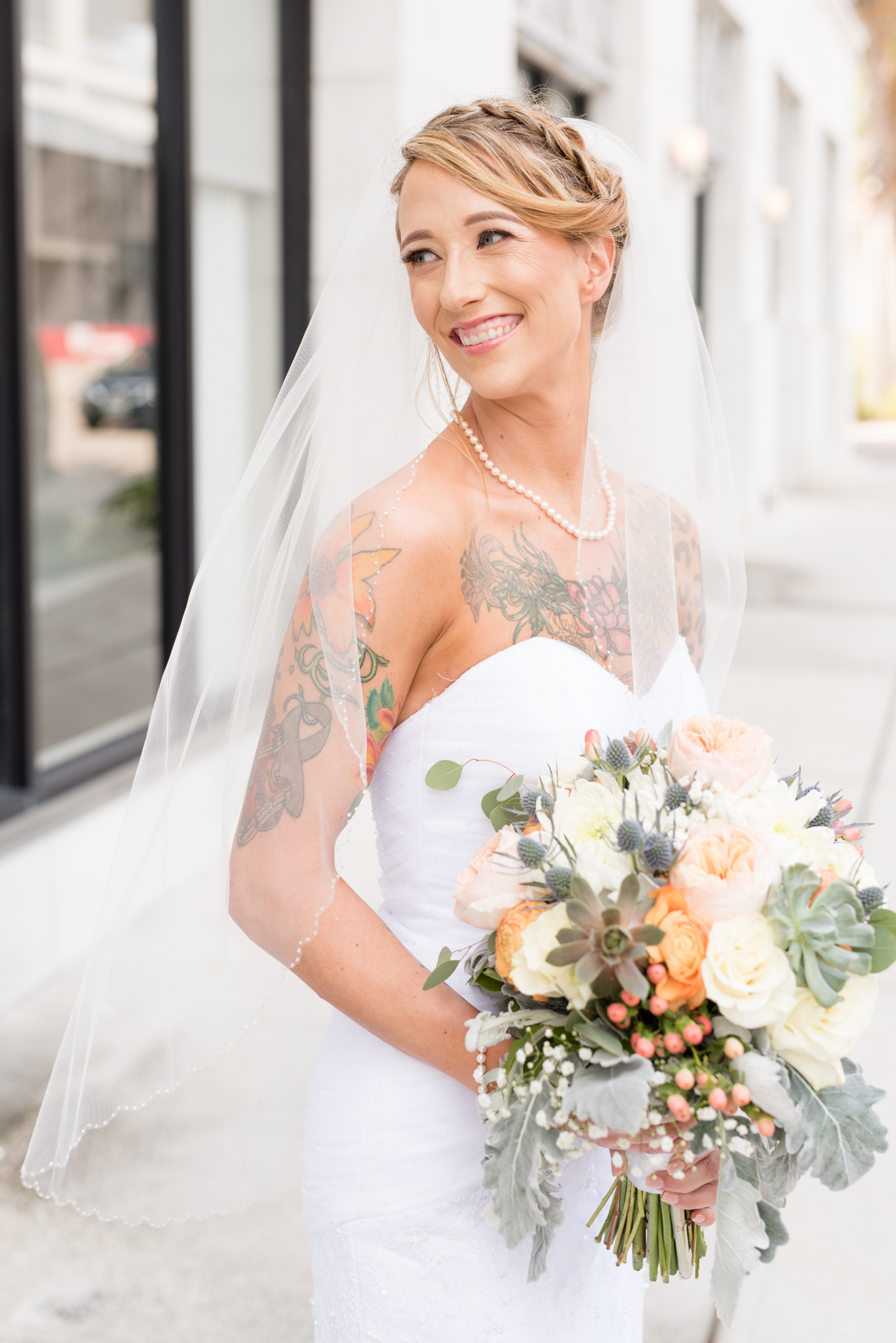 Bride looks over shoulder and smiles.