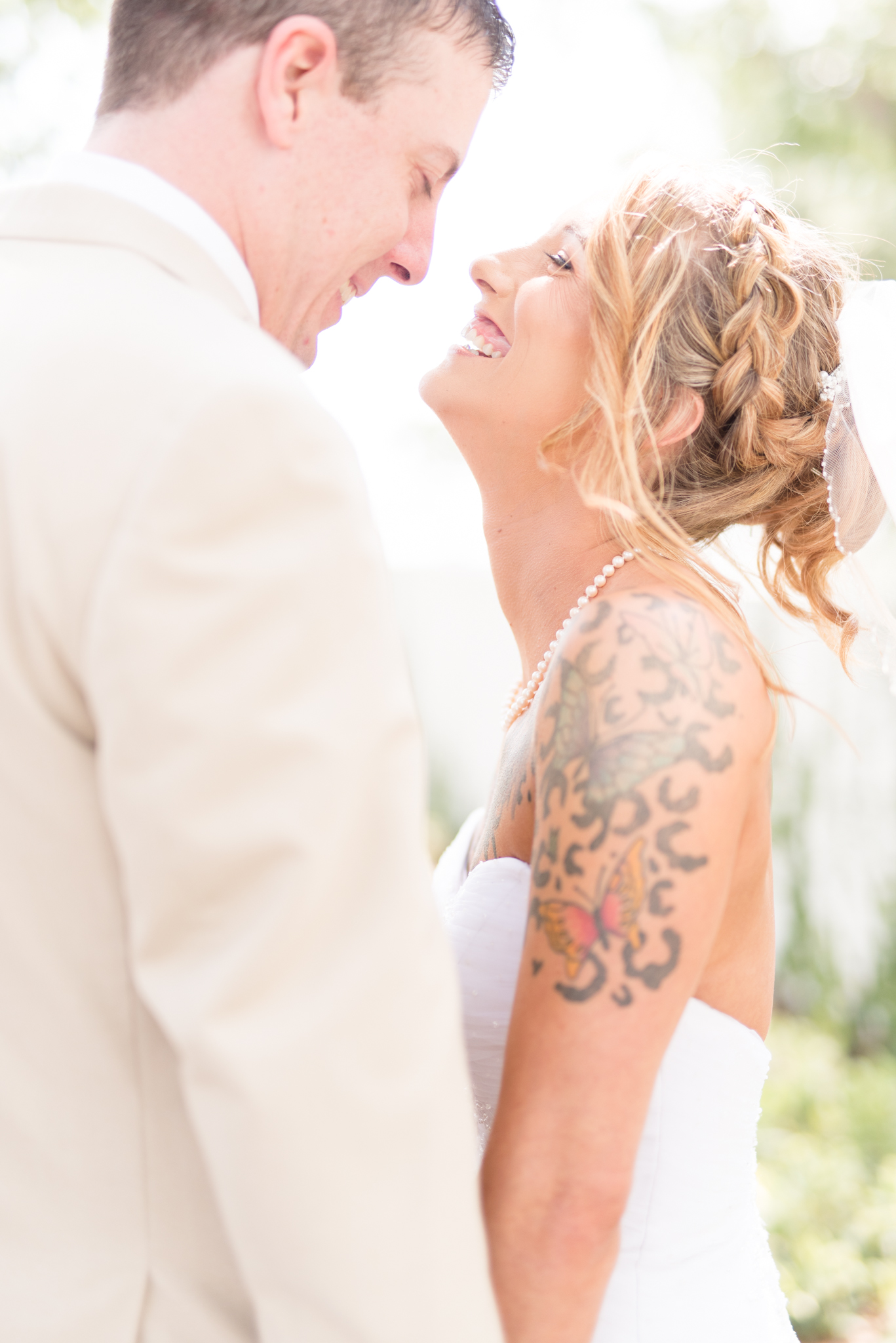 Bride and groom laugh together.