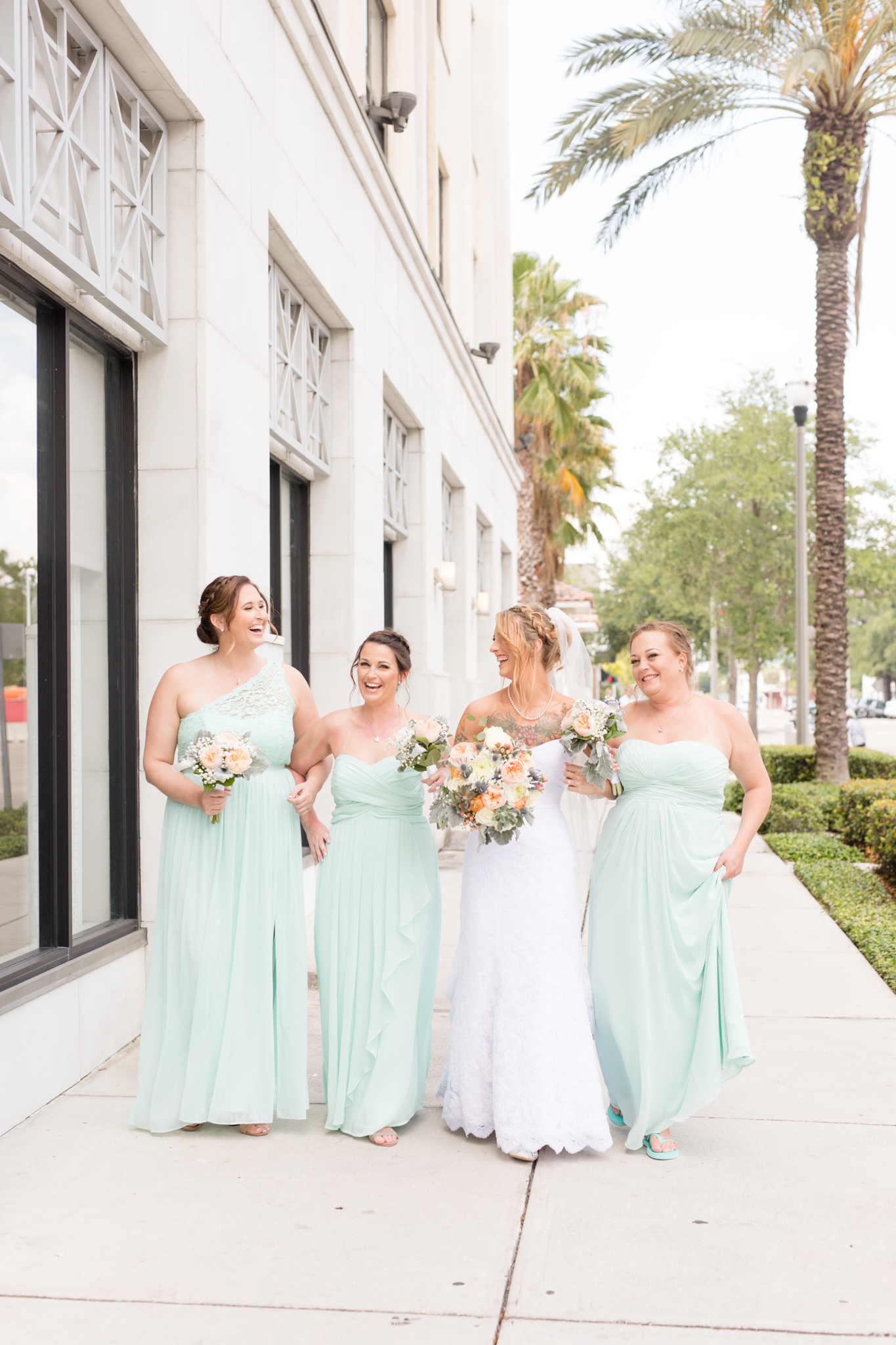Bridal party walks down St. Petersburg sidewalk.