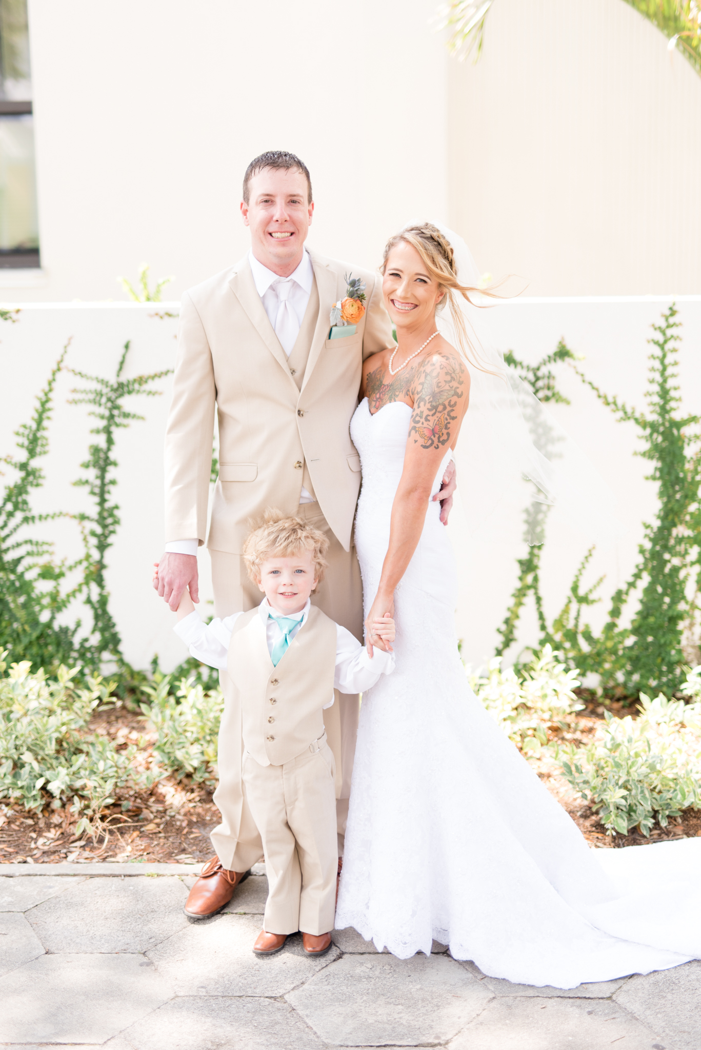 Bride and groom pose with their son.