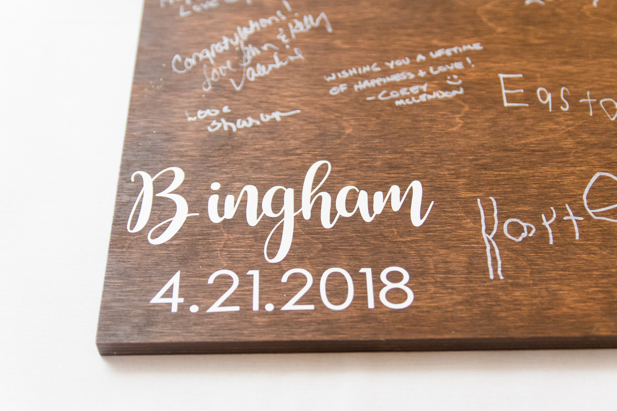 Wooden guest book with signatures.